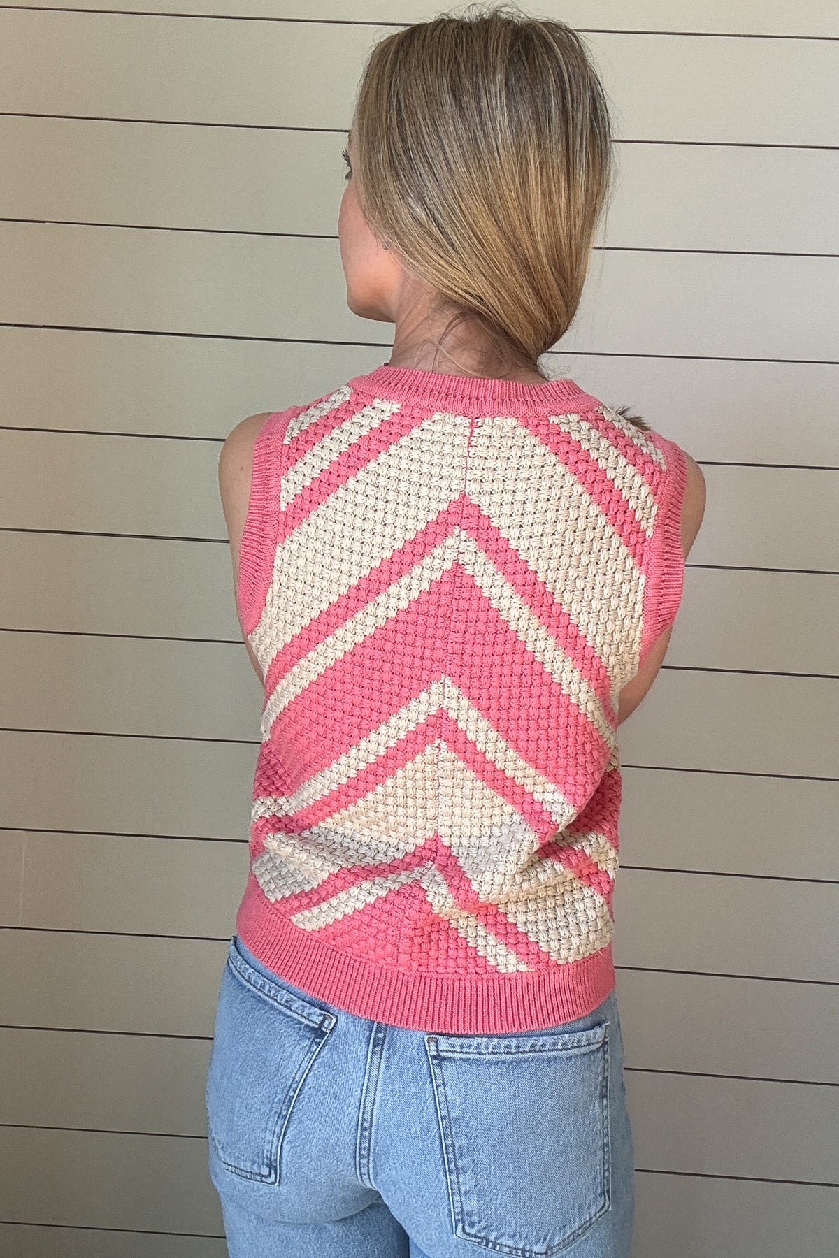 This bold basketweave knit tank is a standout piece with texture and color that pops. Made from 100% cotton, it’s soft, breathable, and perfect for warmer days. The sleeveless cut and crew neckline give it a classic shape, while the pink and cream chevron pattern adds just the right amount of fun. The basketweave knit adds structure without being heavy, making it an easy pick for everyday wear.