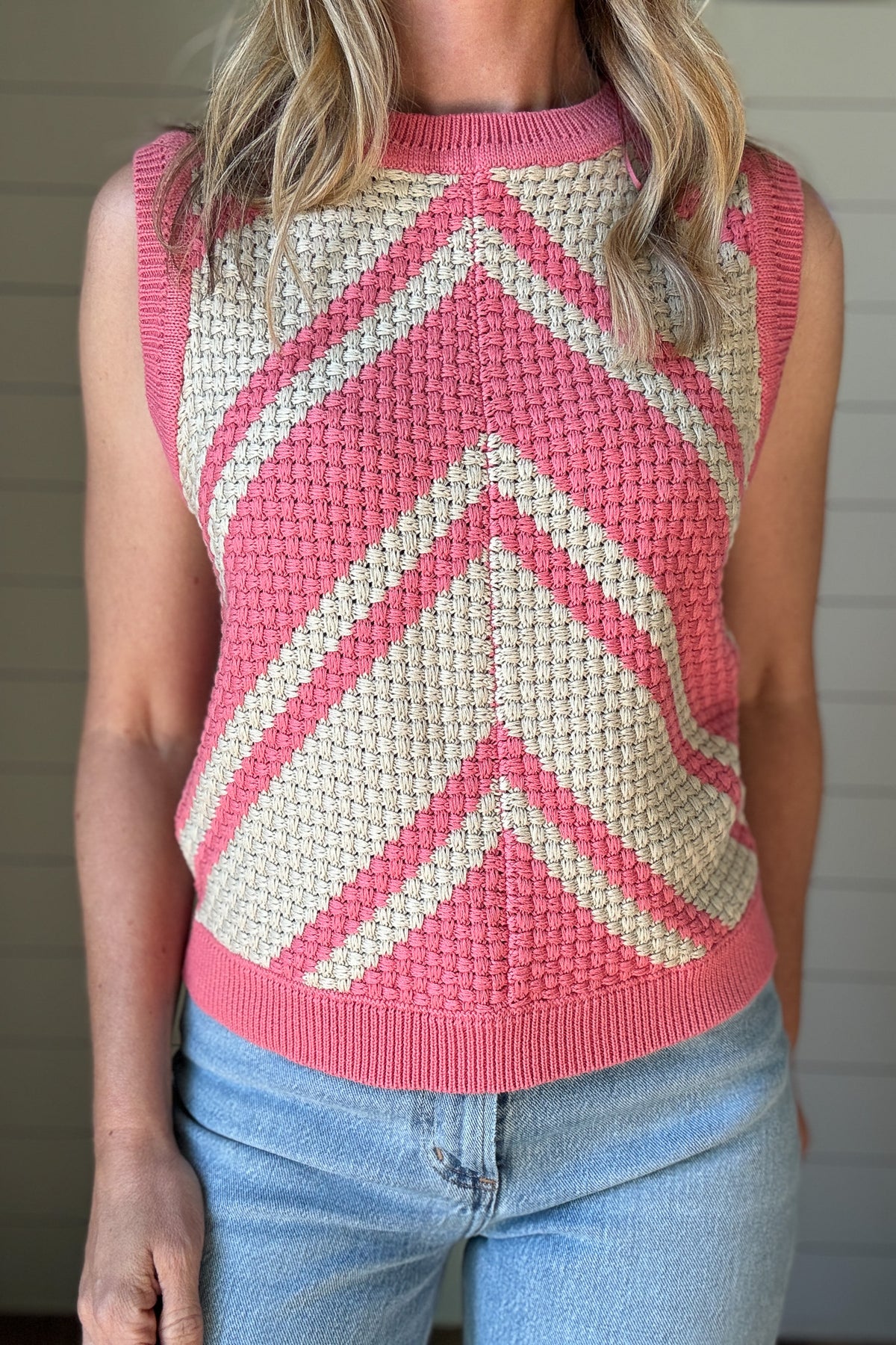 This bold basketweave knit tank is a standout piece with texture and color that pops. Made from 100% cotton, it’s soft, breathable, and perfect for warmer days. The sleeveless cut and crew neckline give it a classic shape, while the pink and cream chevron pattern adds just the right amount of fun. The basketweave knit adds structure without being heavy, making it an easy pick for everyday wear.
