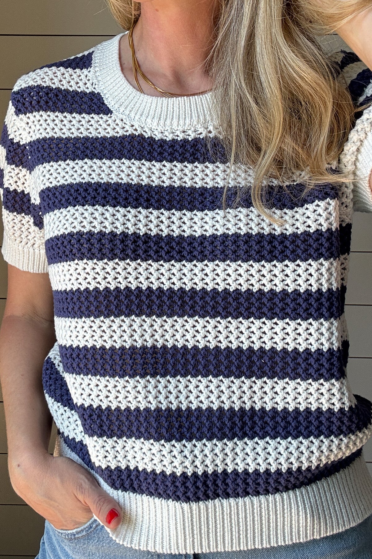 The close knit Blue & White Short Sleeve Top is the perfect blend of timeless style and everyday comfort. Crafted from 100% cotton, this breathable knit top offers a lightweight feel while maintaining a cozy texture. The intricate open-knit pattern showcases alternating blue and white stripes, creating a fresh and vibrant look.
With its classic crew neckline and ribbed trim on the sleeves and hem, this top provides a flattering and effortless fit. The short sleeves make it an easy transitional piece, p