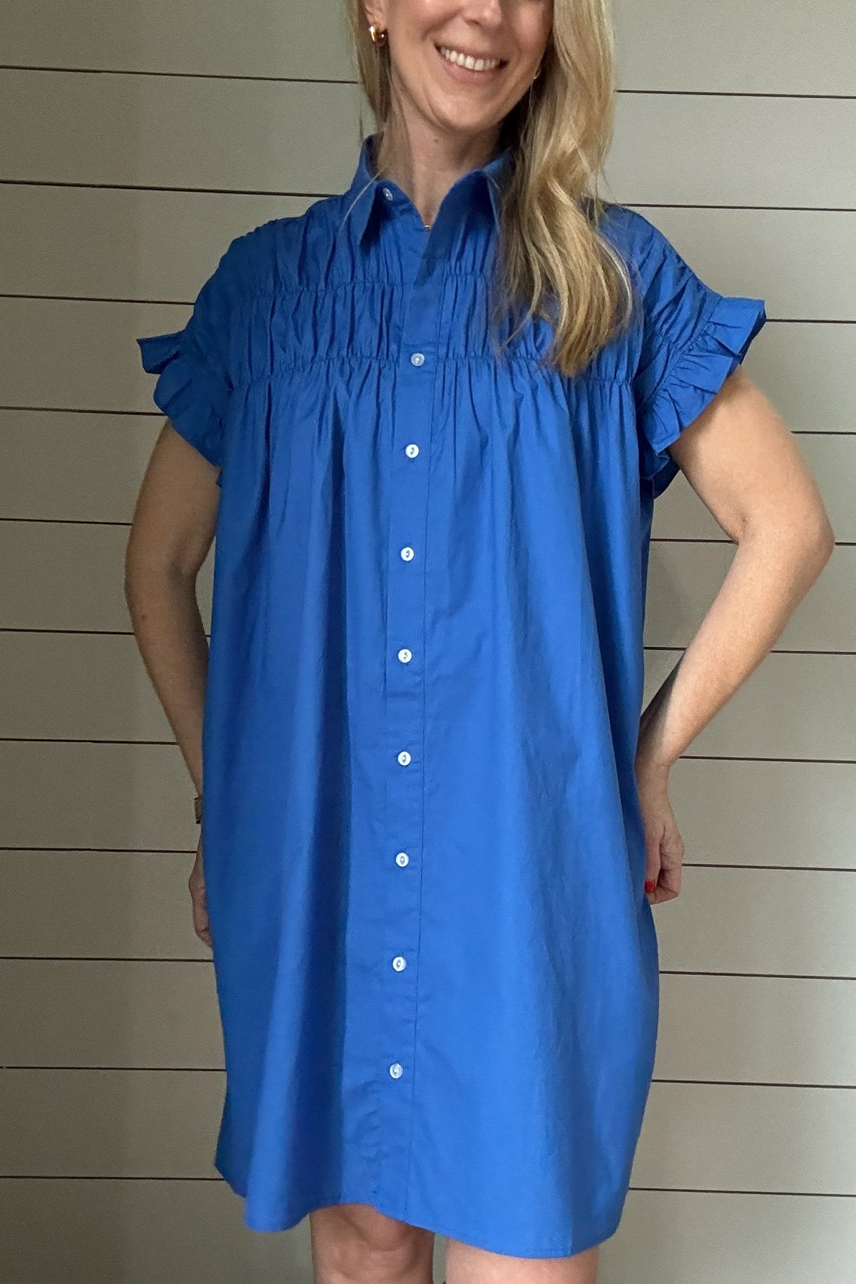 This is the dress that'll take you through Spring & Summer. 100% poplin cotton, feminine shoulder detailing & baby ruffles on the sleeves in the most flattering shade of blue. No pockets or lining on this dress, it is made to keep things lightweight.