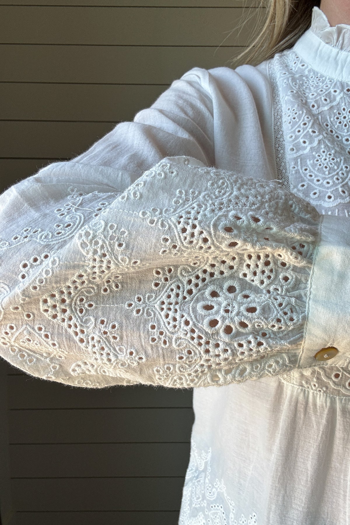 This 100% organic cotton blouse is the perfect blend of delicate charm and effortless style. Designed with intricate eyelet detailing, it adds a feminine touch to any look. The lightweight, breathable fabric makes it a go-to for warm days, while the soft cotton keeps you comfortable all day long.