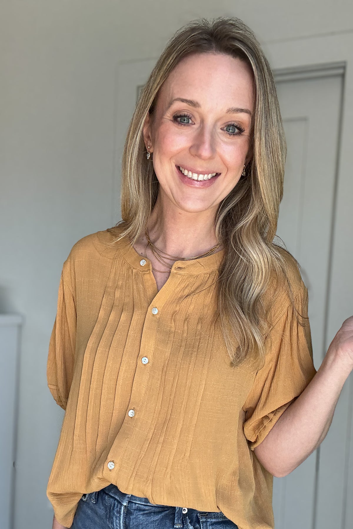 Stay golden in our Goldrod Blouse! This lightweight, button-front top features pin tuck detailing and elastic yellow sleeves for a playful touch. Whether tucked in or untucked, this Goldenrod top will give you that effortless, slightly below look.