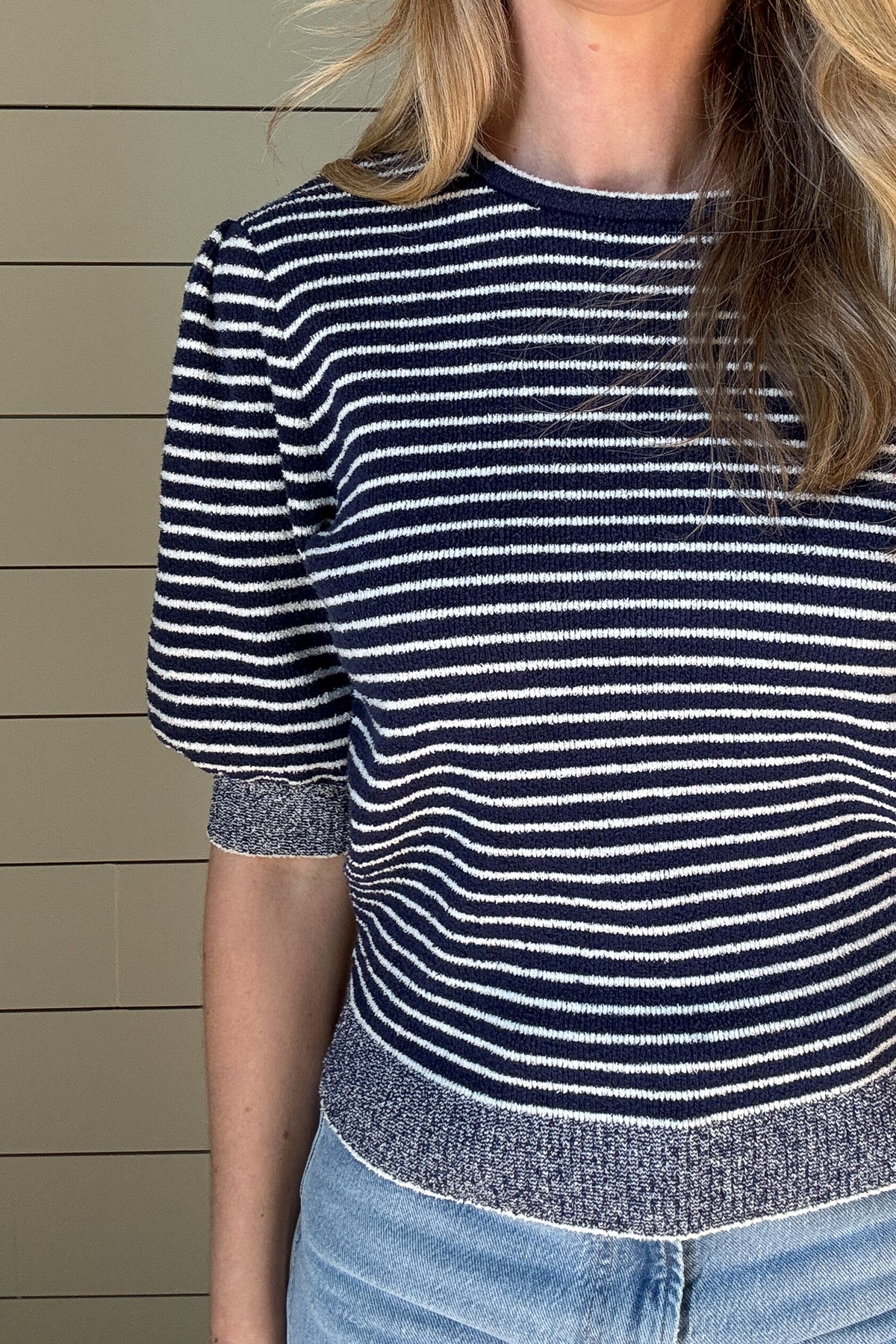 Get ready to rock this Navy Striped Short Sleeve Knit Top! Made with recycled materials, this French-designed sweater features a fitted bodice and a classic style with a playful twist - a striped bodice with heathered edging.
Perfect for adding a touch of charm to your wardrobe. 
