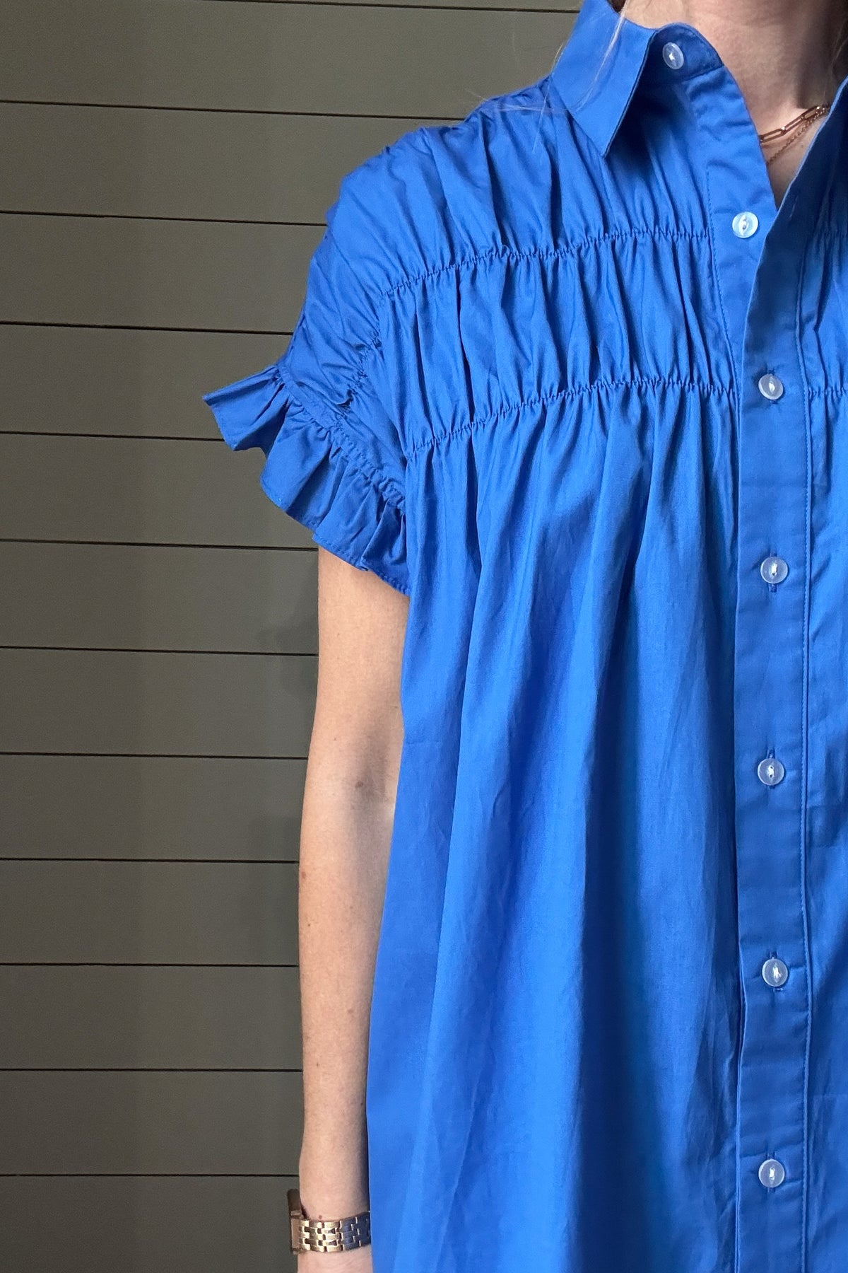 This is the dress that'll take you through Spring & Summer. 100% poplin cotton, feminine shoulder detailing & baby ruffles on the sleeves in the most flattering shade of blue. No pockets or lining on this dress, it is made to keep things lightweight.