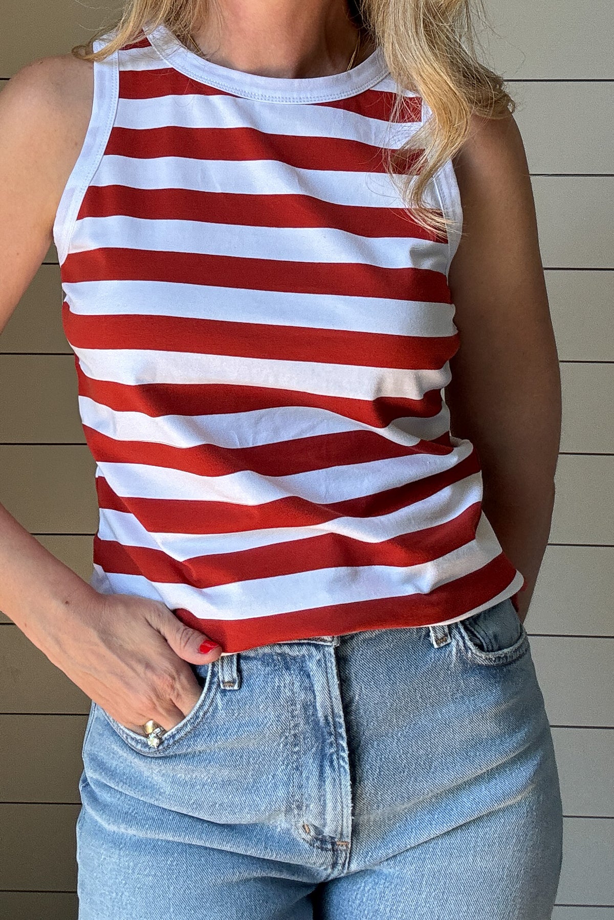 The Classic Red & White Striped Tank is a must-have staple for effortless, everyday style. Made from a soft and breathable blend of 98% cotton and 2% spandex, this tank offers the perfect amount of stretch while maintaining its structured shape. The bold red and white stripes bring a timeless, nautical-inspired vibe, making it an easy go-to for warm days and layering.