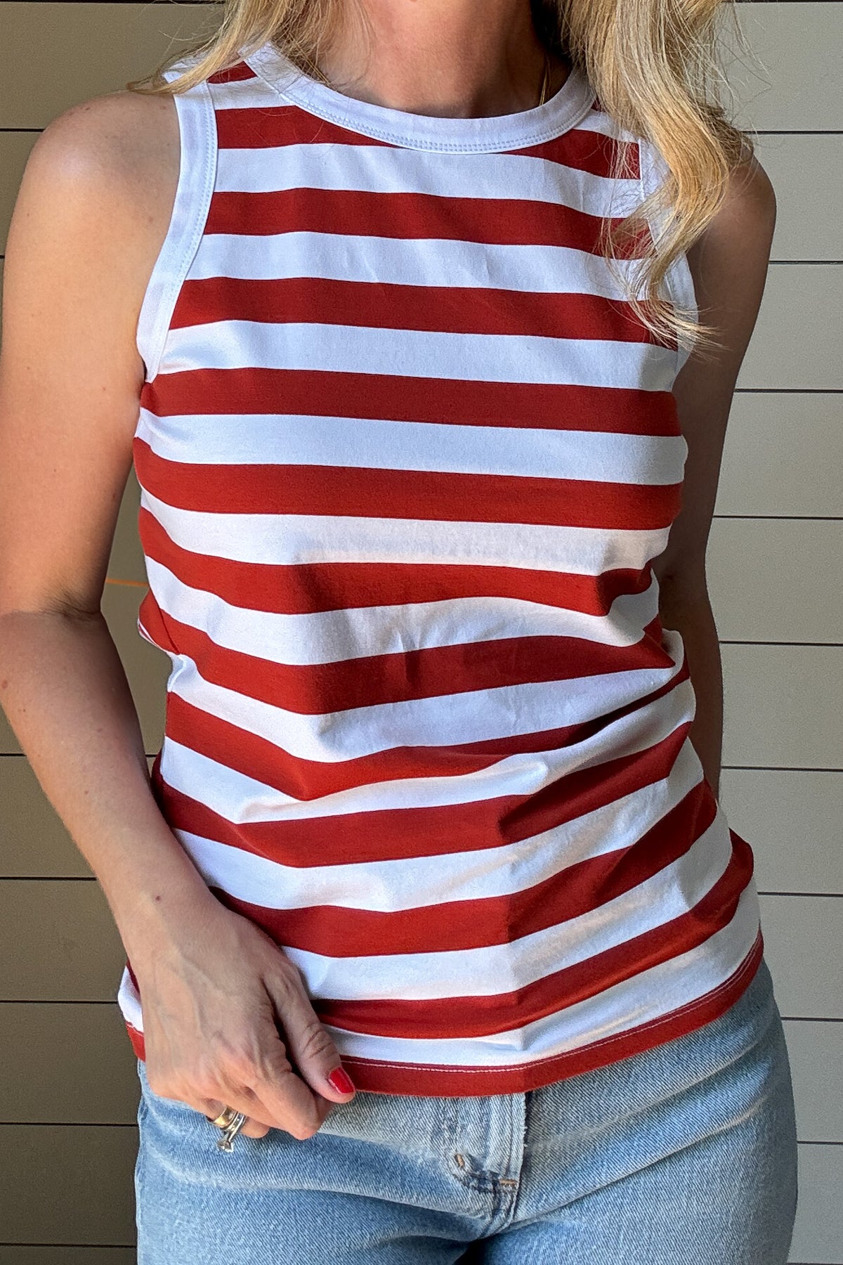 The Classic Red & White Striped Tank is a must-have staple for effortless, everyday style. Made from a soft and breathable blend of 98% cotton and 2% spandex, this tank offers the perfect amount of stretch while maintaining its structured shape. The bold red and white stripes bring a timeless, nautical-inspired vibe, making it an easy go-to for warm days and layering.