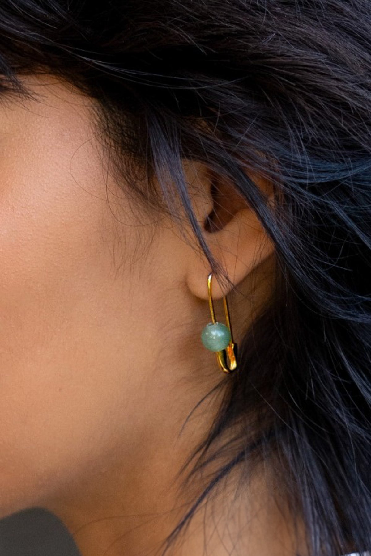 Our Roxy Stone Safety Pin Earring offers eye catching style with its aventurine stone and fully functioning safety pin motif.