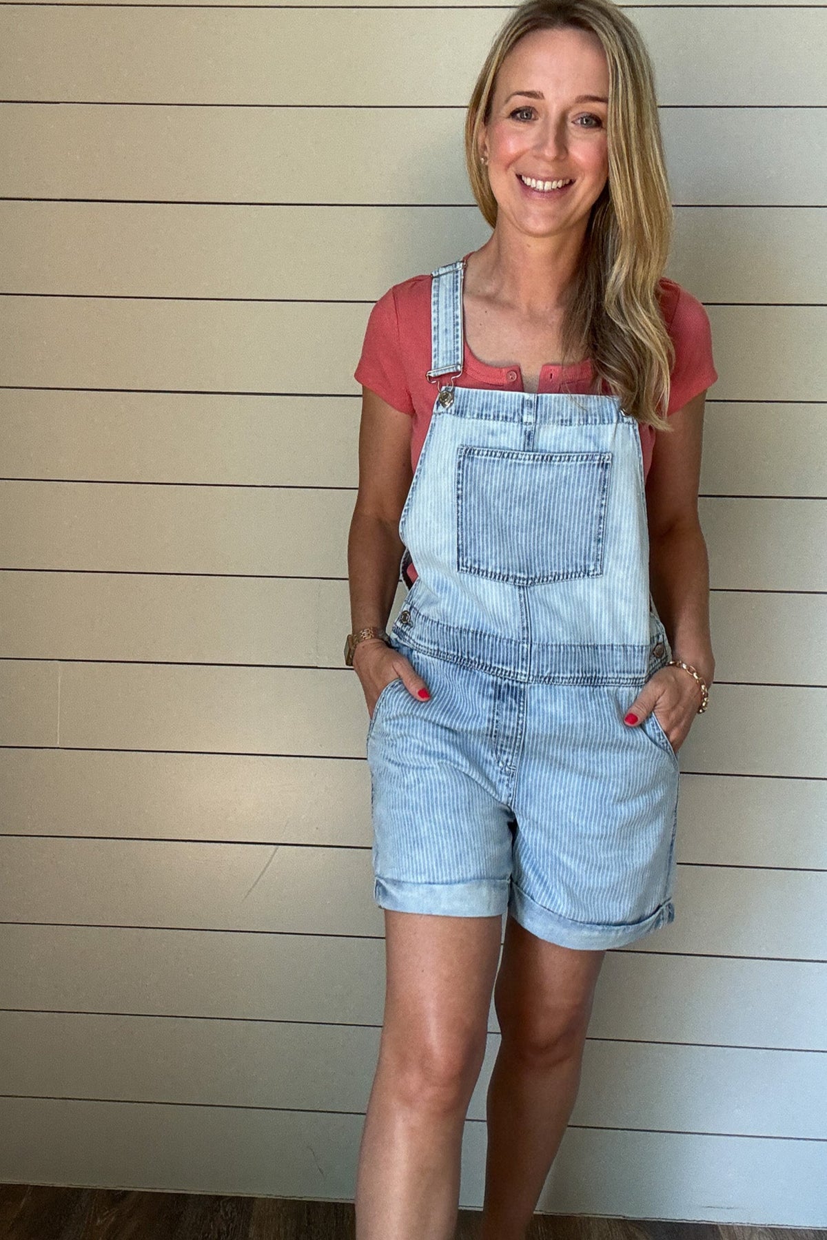 Laid-back and cute without trying too hard. These light-wash striped shortalls are made for summer days. With a relaxed fit, front chest pocket, and tacked rolled cuffs, they strike the perfect balance of casual and polished. Adjustable straps let you customize your fit, and side buttons make them easy to slip on and go. Pair with any tank or tee for a playful, easy outfit.