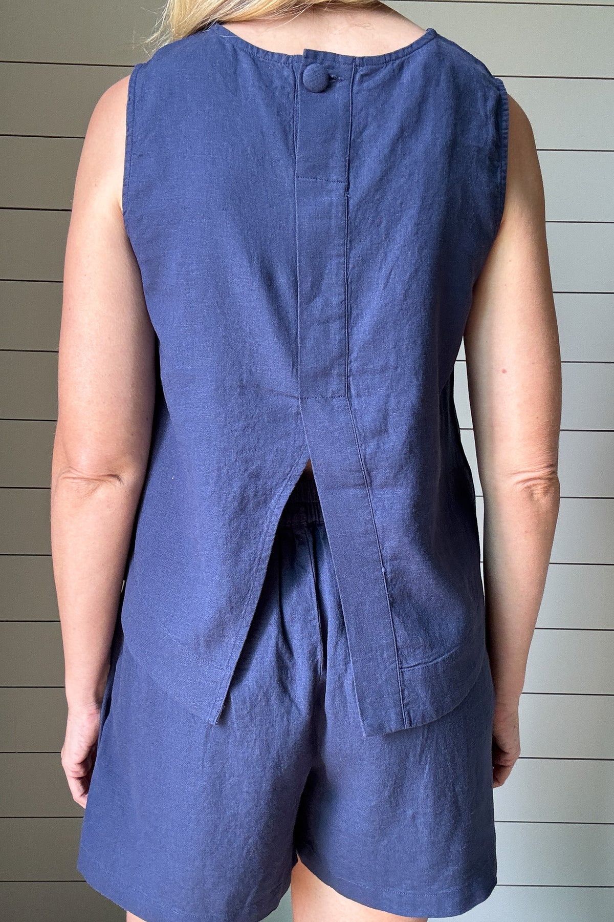 These navy linen blend shorts are your go-to for effortless style and comfort. Designed with soft pleats and side pockets, they offer a polished feel without losing their laid-back charm. Pair with the matching top or wear with a tee for an everyday look.