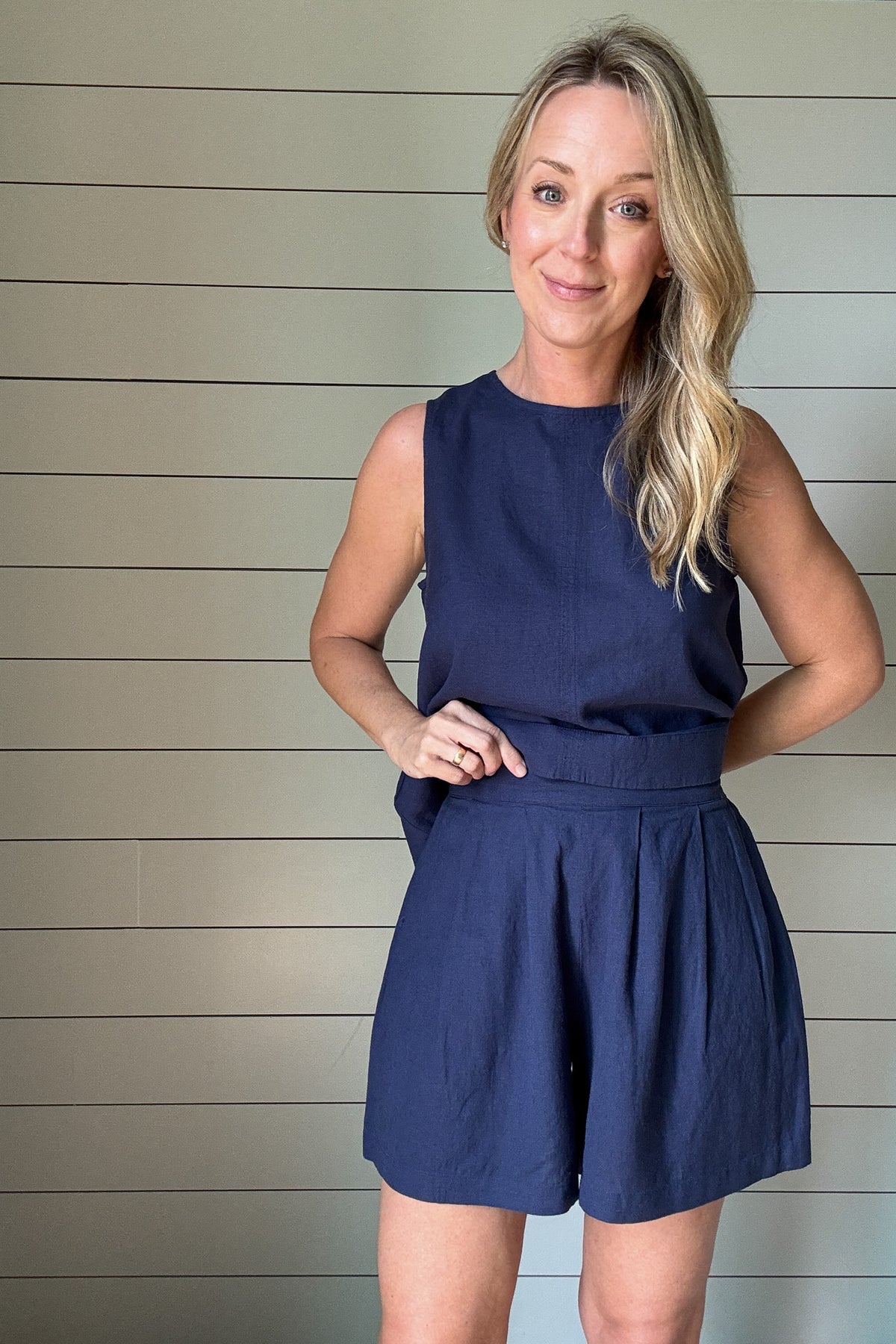 These navy linen blend shorts are your go-to for effortless style and comfort. Designed with soft pleats and side pockets, they offer a polished feel without losing their laid-back charm. Pair with the matching top or wear with a tee for an everyday look.