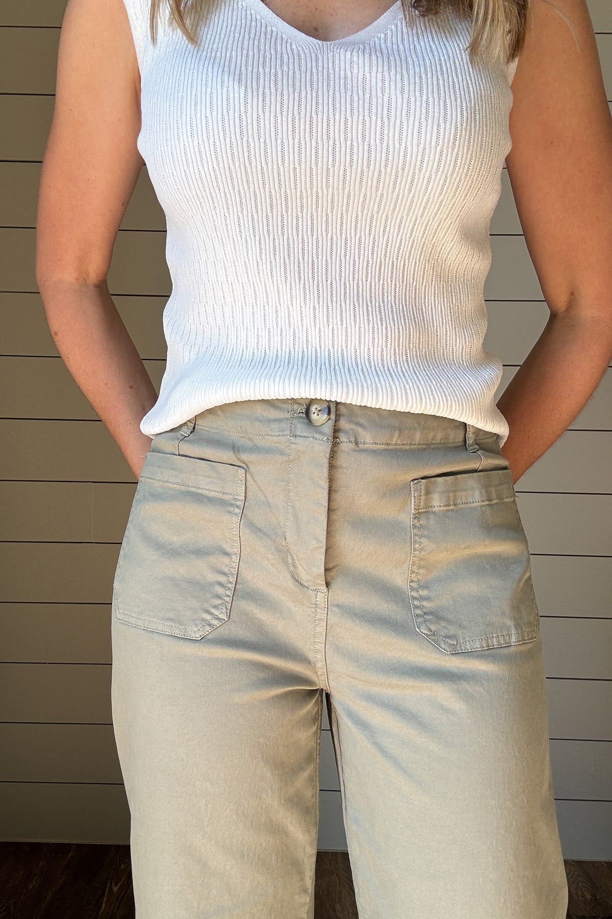 Introducing the luxurious Valeria Pant, a wide leg, cropped chino pant in a soft sage green. With intricate front and back pocket detailing and a button front, this pant exudes sophistication and exclusivity. Elevate your wardrobe and make a statement with this elegant and tasteful piece.