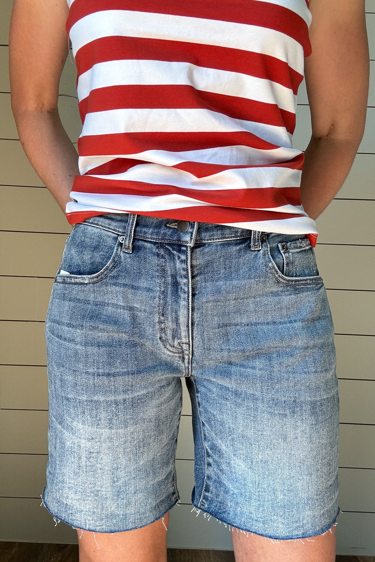 Meet your new favorite denim short! With a 6.5” raw hem that can be rolled for a customized length, these shorts offer effortless versatility. Designed with a straight cut that fits comfortably in the thigh—no clinging here—while gently tapering at the waist for a flattering fit. Perfect for the mom who wants a modern, stylish short without the “mom short” feel. Dress them up or down for an easy, go-to summer look!
