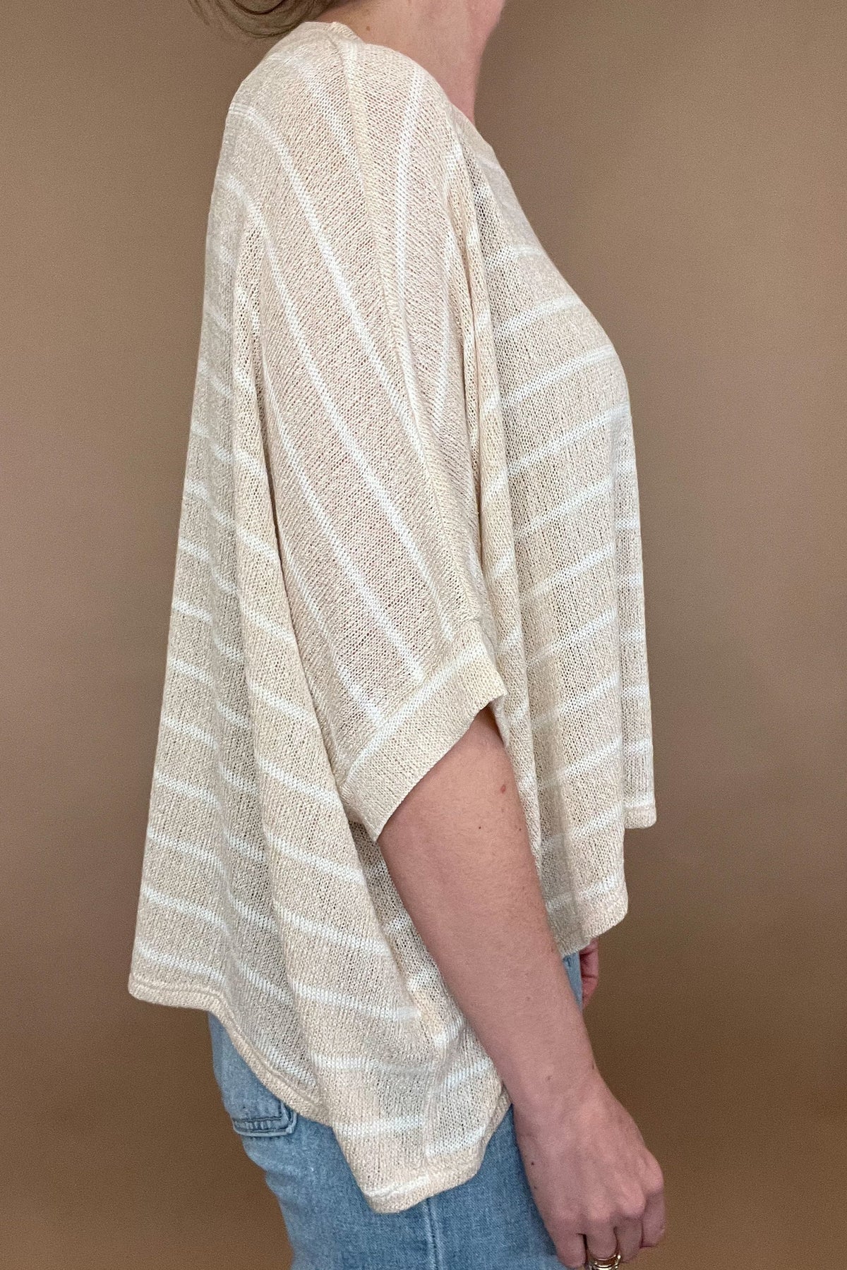 <span><br>Experience comfort and style with our Carefree Lightweight Top. Made for layering over a tank, this loose-fit poncho top is perfect for any casual occasion. Its lightweight design and short sleeves make it an ideal match with light wash denim. Upgrade your wardrobe with this must-have piece. </span>&nbsp;