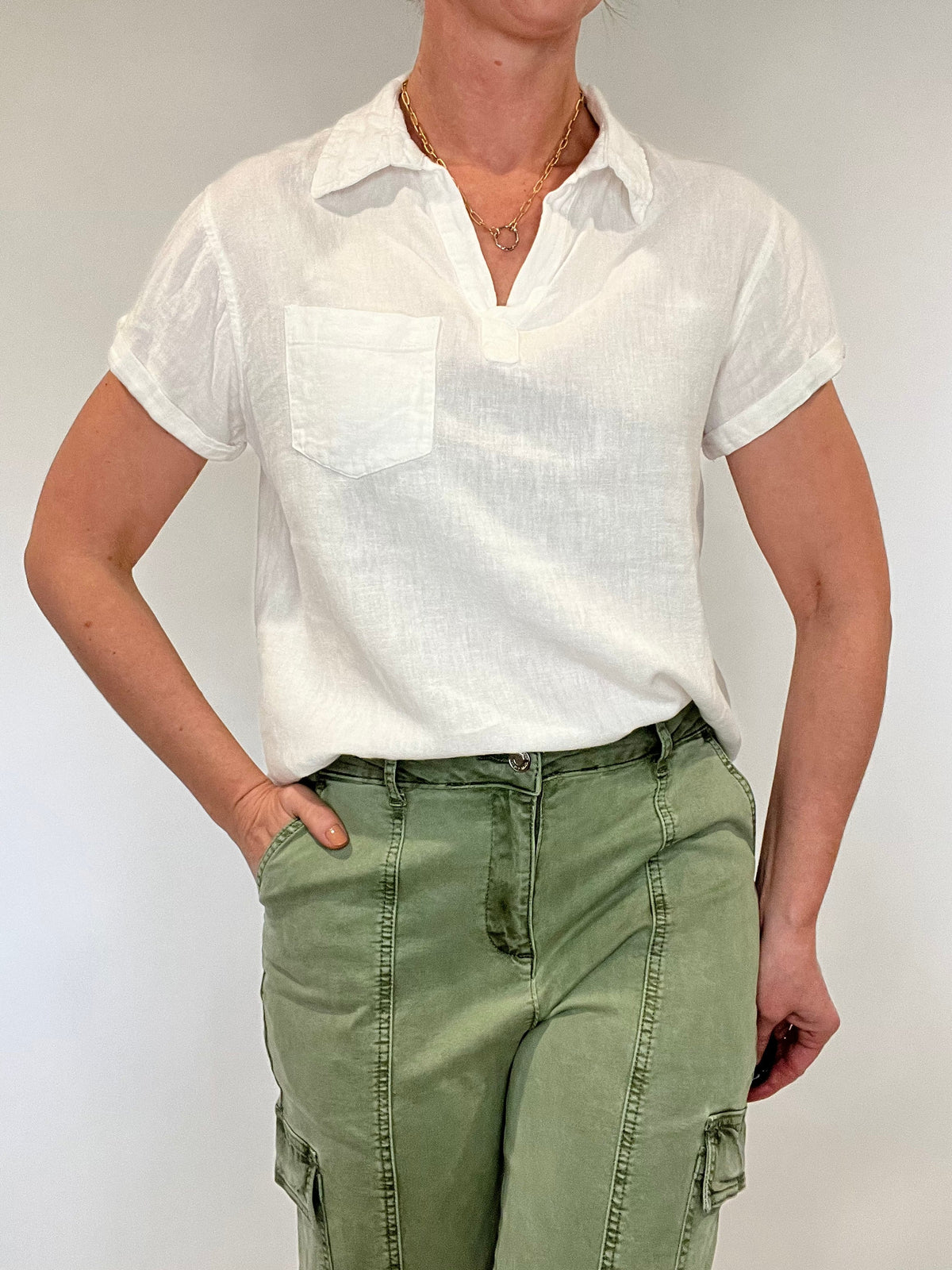 Linen blend perfection. This is your go to everything white top; layer it under a jacket, pair with pants or shorts, dress it up or dress it down but know that however you style this top you will look and feel put together.