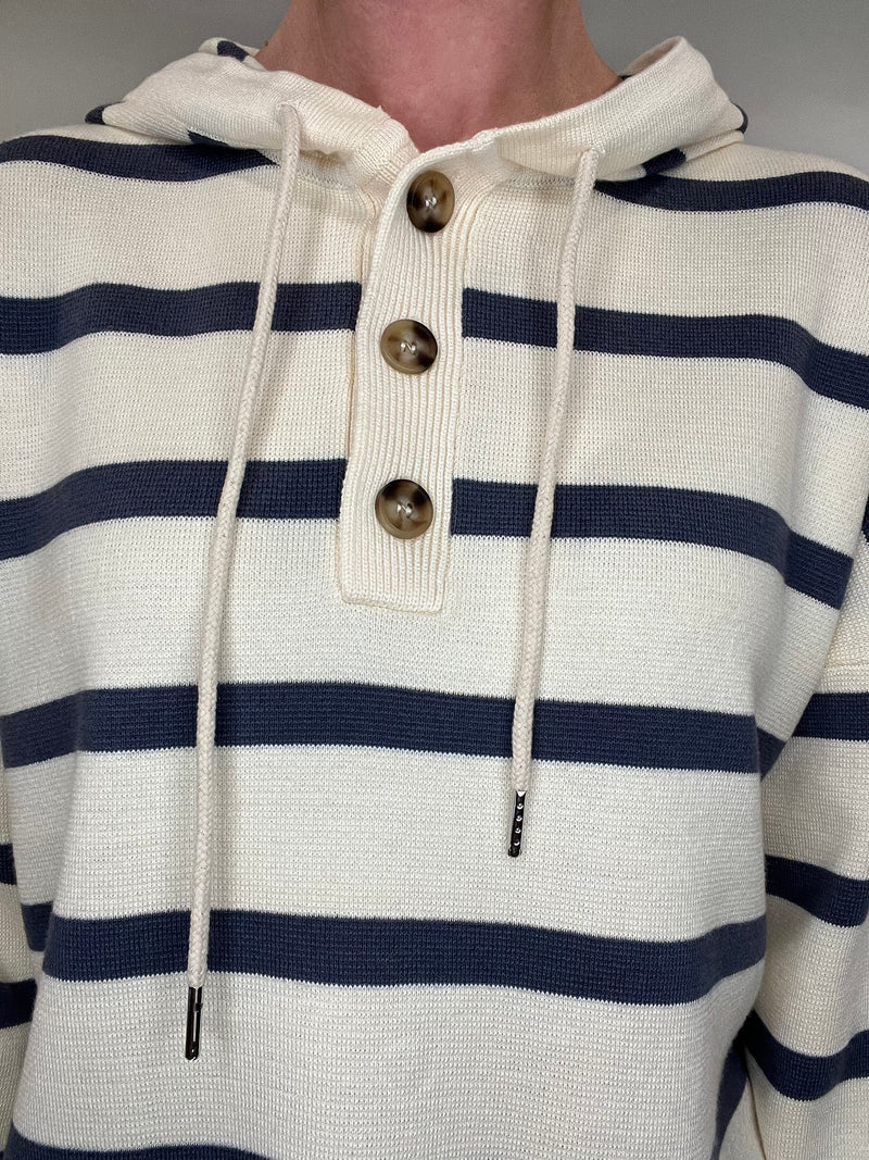 Sail away in style with The Nautical Hoodie. This luxurious heavy-weight, fine knit sweater features elegant nautical stripes in navy and ecru, exuding effortless chic. Leave the sweatshirt behind and elevate your wardrobe with this gorgeous piece.