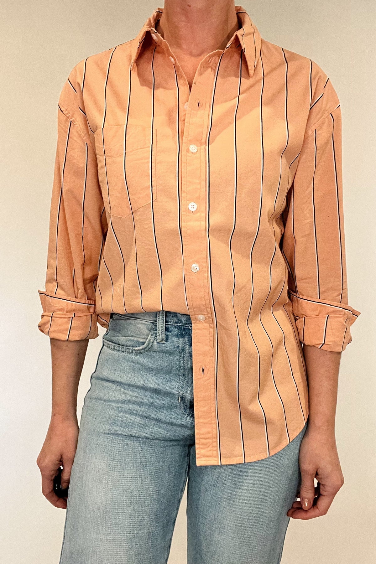 Indulge in effortless elegance with our Just Peachy Striped Shirt. Crafted from 100% cotton, this classic cut shirt features delicate peach tones and black and white pin stripes for a timeless yet modern look. Complete with a single chest pocket, it's the perfect blend of luxury and style.