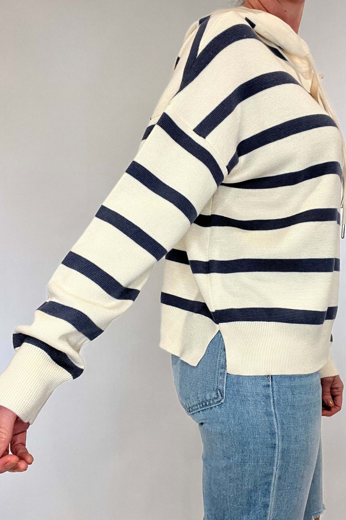 Sail away in style with The Nautical Hoodie. This luxurious heavy-weight, fine knit sweater features elegant nautical stripes in navy and ecru, exuding effortless chic. Leave the sweatshirt behind and elevate your wardrobe with this gorgeous piece.