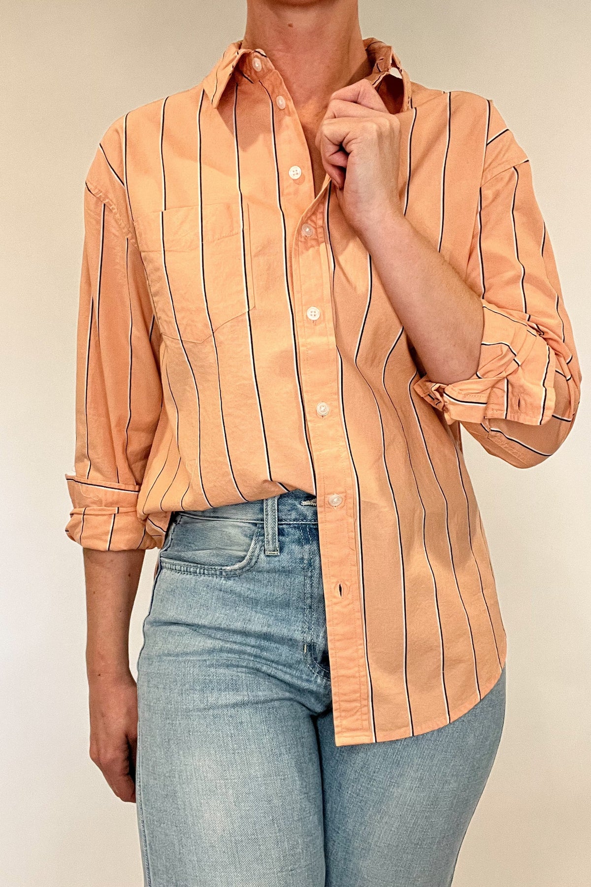 Indulge in effortless elegance with our Just Peachy Striped Shirt. Crafted from 100% cotton, this classic cut shirt features delicate peach tones and black and white pin stripes for a timeless yet modern look. Complete with a single chest pocket, it's the perfect blend of luxury and style.