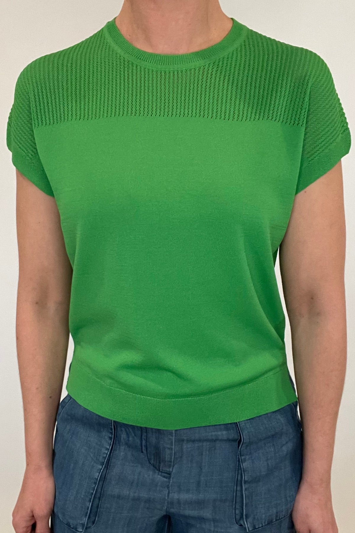 Elevate your spring style with our Laser Cut Summer Sweater. The open weave design over the shoulders and upper chest adds a touch of lightness to this vibrant and chic piece. With color options in grass green and bright orange, pair it effortlessly with chambray pants or white denim for a stylish look.