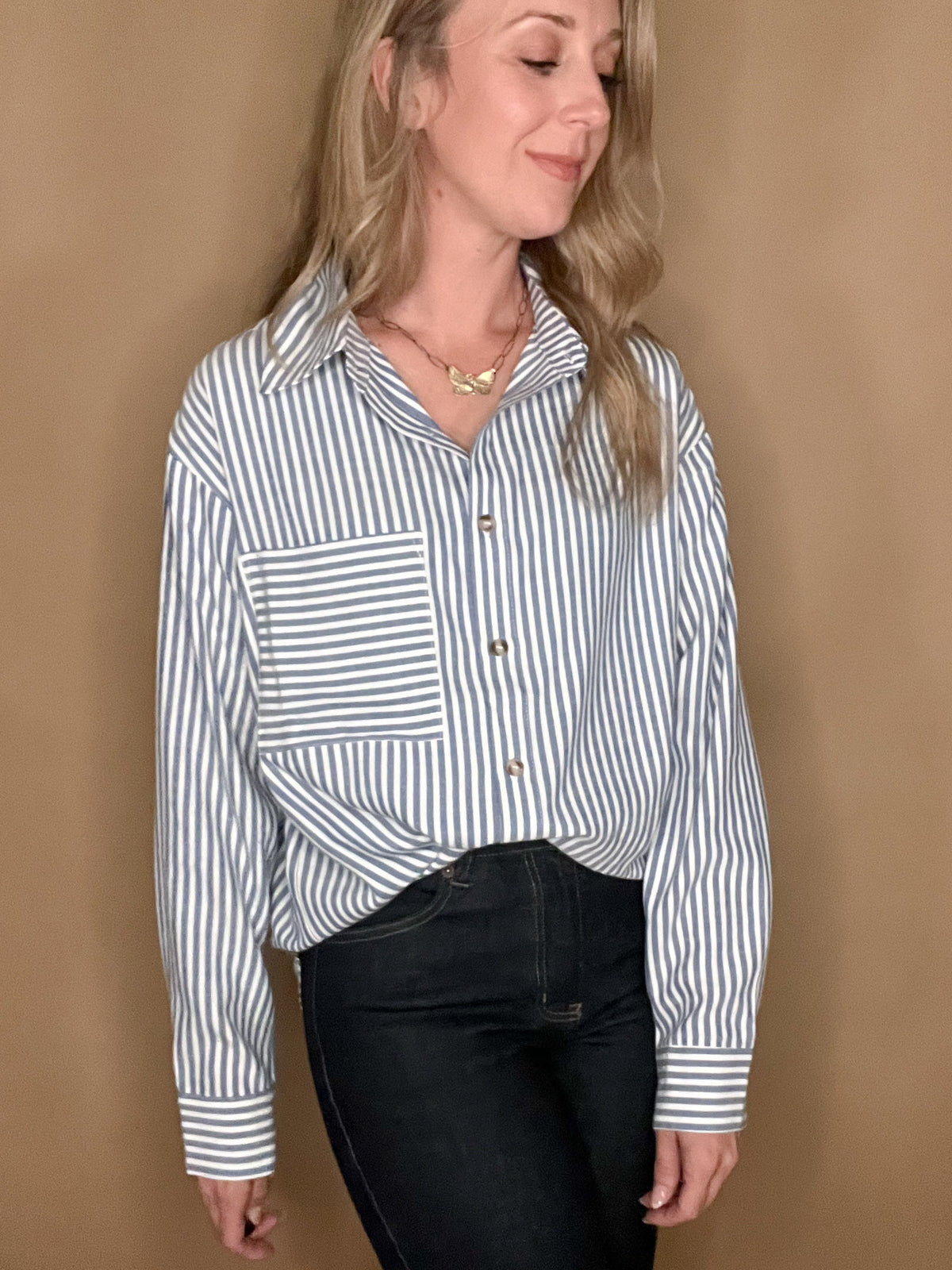 This Classic Stripe Shirt is perfect for the modern sophisticate. Crafted from a luxurious cotton-poly blend, it is soft and stylish while also resistant to wrinkles and maintaining its shape. The classic blue vertical striped design is complemented with a statement front pocket featuring horizontal stripes for an eye-catching finish.