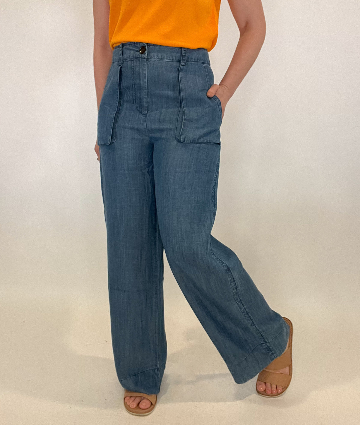 Upgrade your wardrobe with our sophisticated Wide Leg Chambray Pant. Made with luxurious chambray fabric and featuring unique 3d pockets, a button front, and an elastic waist in the back for ultimate comfort. Perfect for spring, these pants offer the look of denim with unmatched comfort. Elevate your style with these pants.