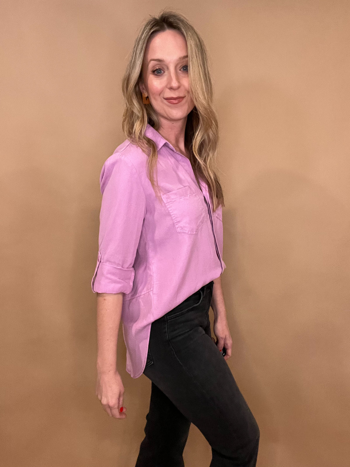 Effortlessly pretty for spring, our Lilac Dream Button Front Top is made from sustainable tencel fabric for a soft and eco-friendly feel. With roll sleeves and slit back tails, this top offers a versatile and chic style. Perfect for the conscious fashionista who loves a touch of femininity.