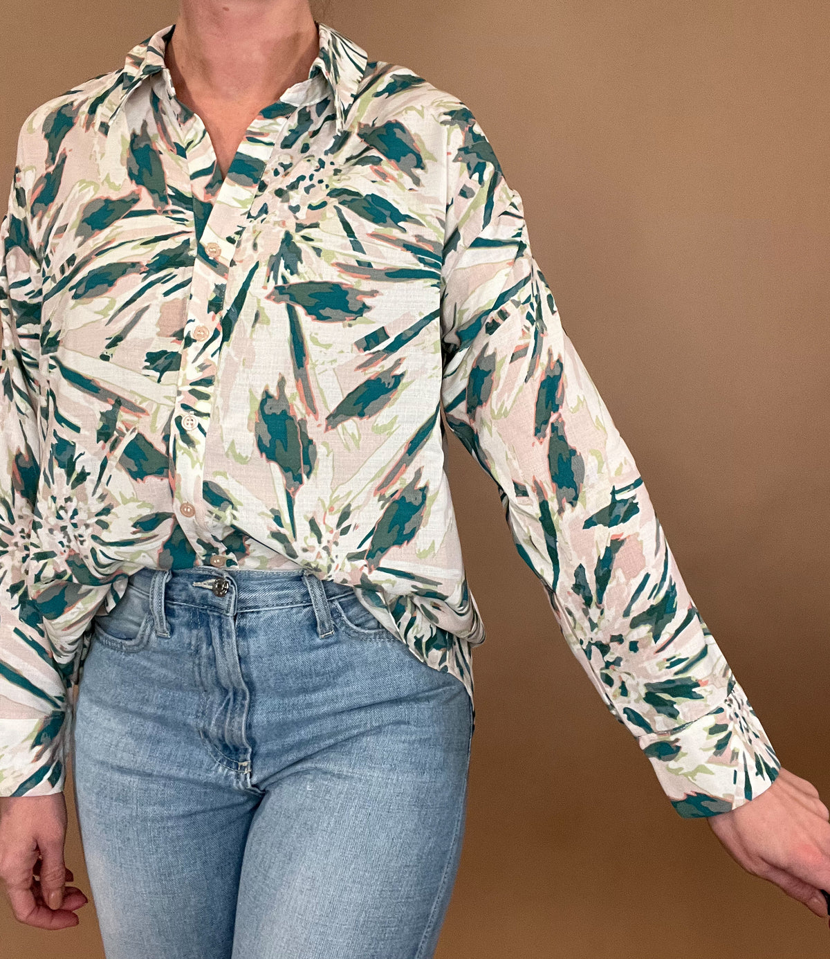 <br>The All Buttoned Up Blouse features an abstract floral print and a button-up front and back yoke, giving it a sophisticated and stylish look. Its long sleeves make it perfect for the spring season. Elevate your wardrobe with this unique and elegant blouse.