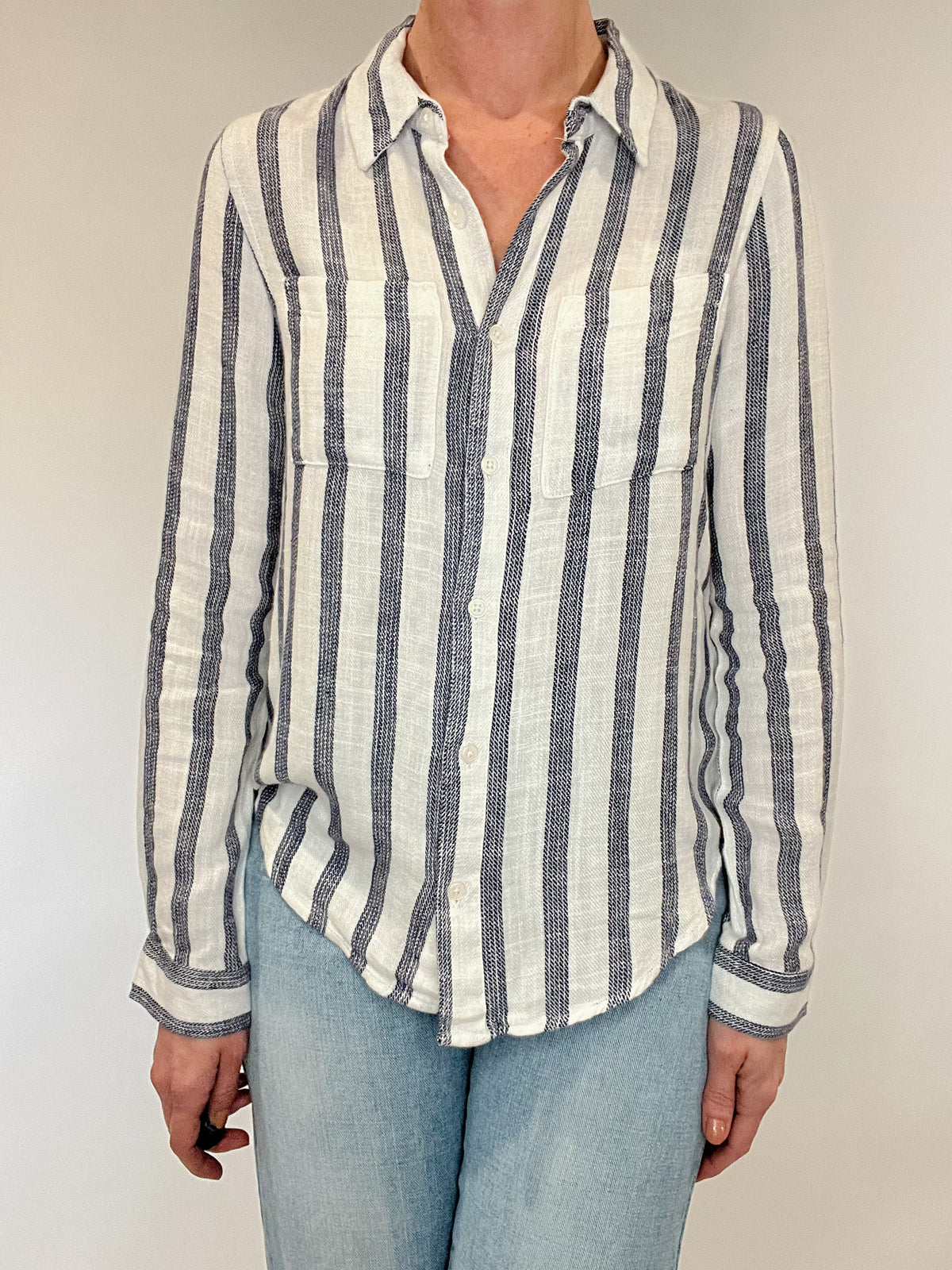 Introducing the Bestie Shirt in Blue, your new companion for the spring and summer season. Made with a luxurious linen blend, this stylish striped shirt is versatile enough to pair with any casual denim and sandals. Let it be your go-to piece for effortless fashion.