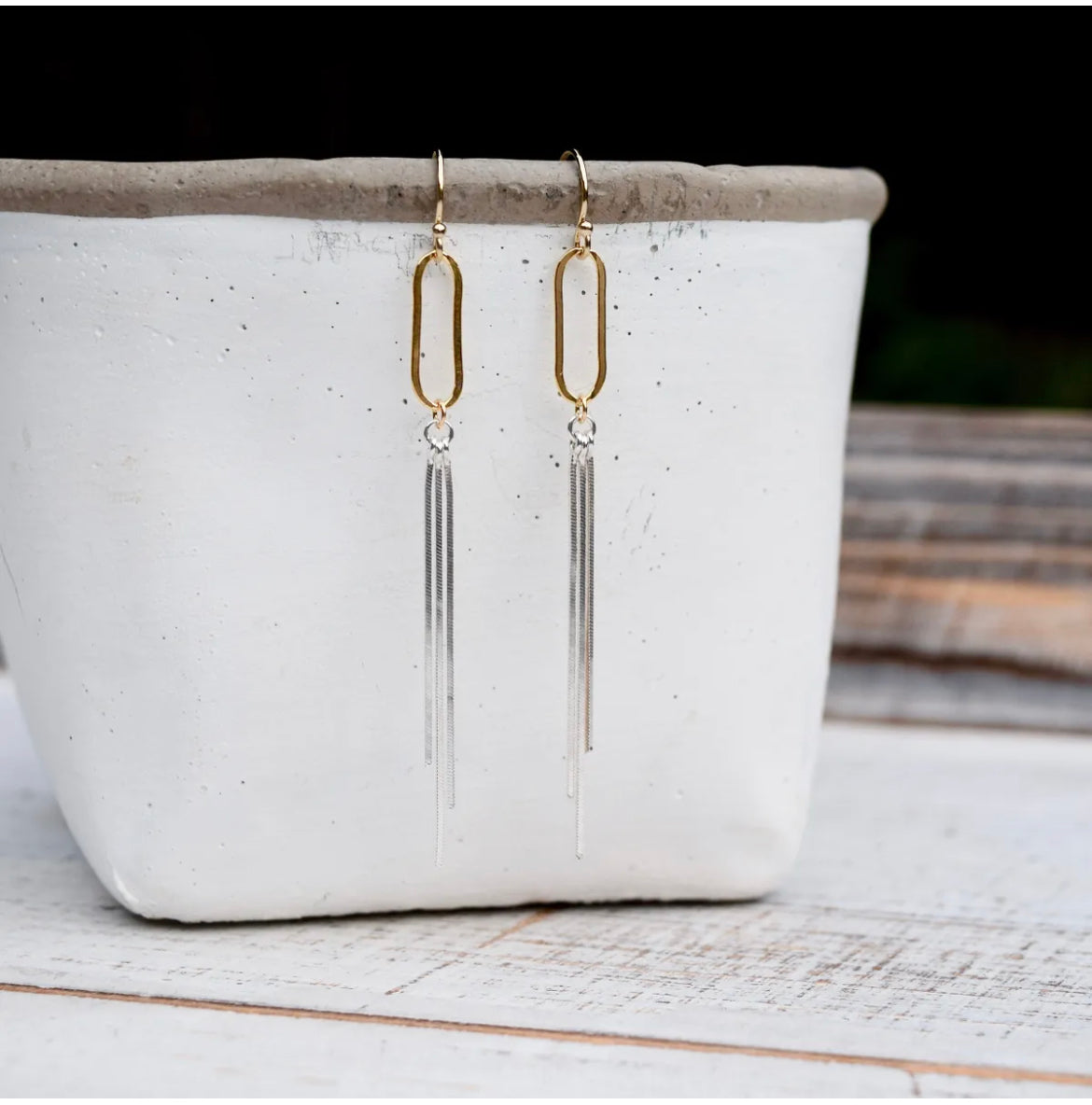 Elevate your look with our Artisan Paperclip Tassel Earrings, featuring 14k gold filled chain links and sterling silver tassels on 14k gold filled ear wire. Each earring measures approximately 2 3/4 inches, adding a touch of elegance and handcrafted charm to your ensemble. Handmade in the USA with care and attention to detail, these earrings are the perfect statement piece for any occasion.