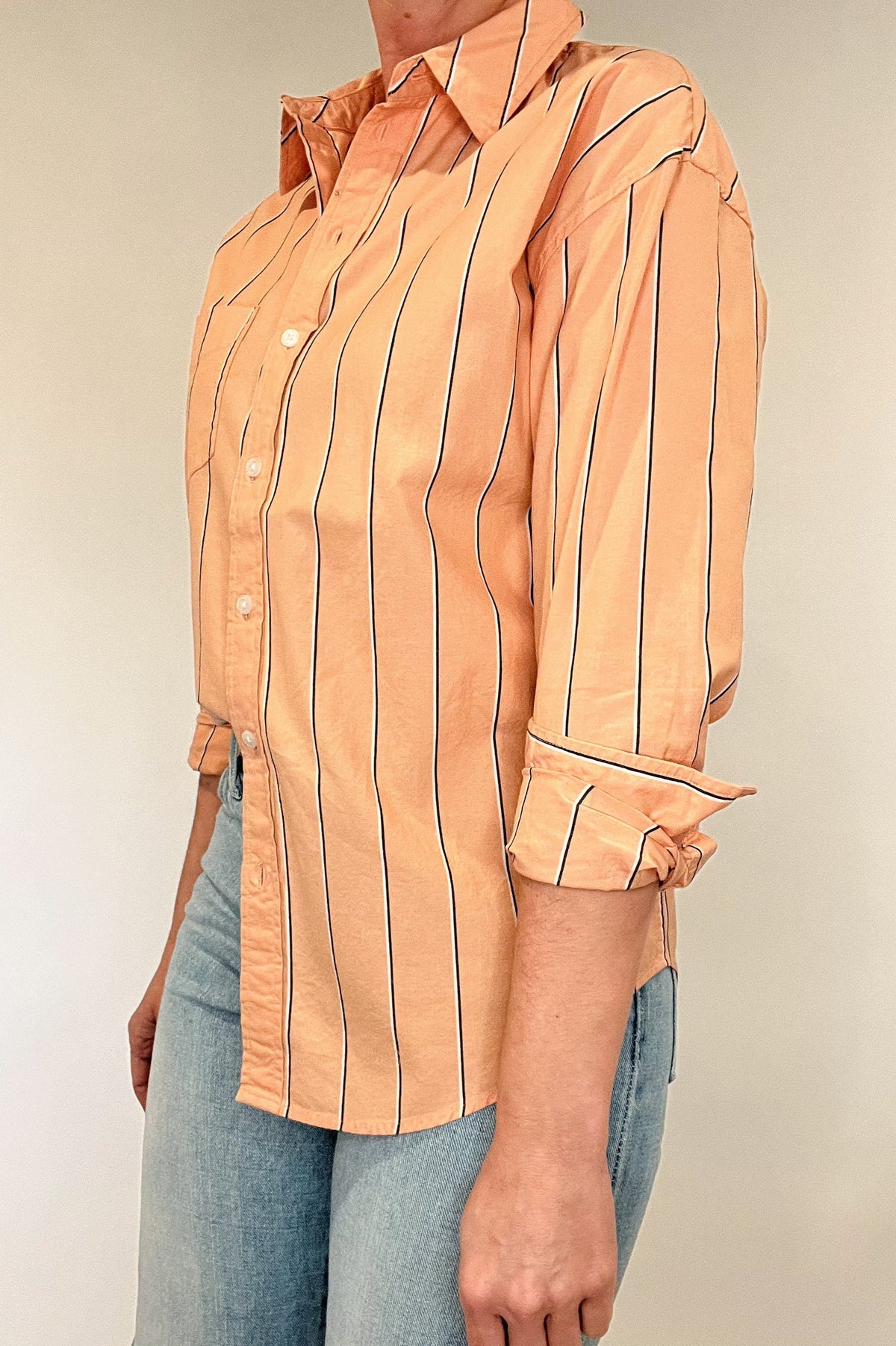 Indulge in effortless elegance with our Just Peachy Striped Shirt. Crafted from 100% cotton, this classic cut shirt features delicate peach tones and black and white pin stripes for a timeless yet modern look. Complete with a single chest pocket, it's the perfect blend of luxury and style.