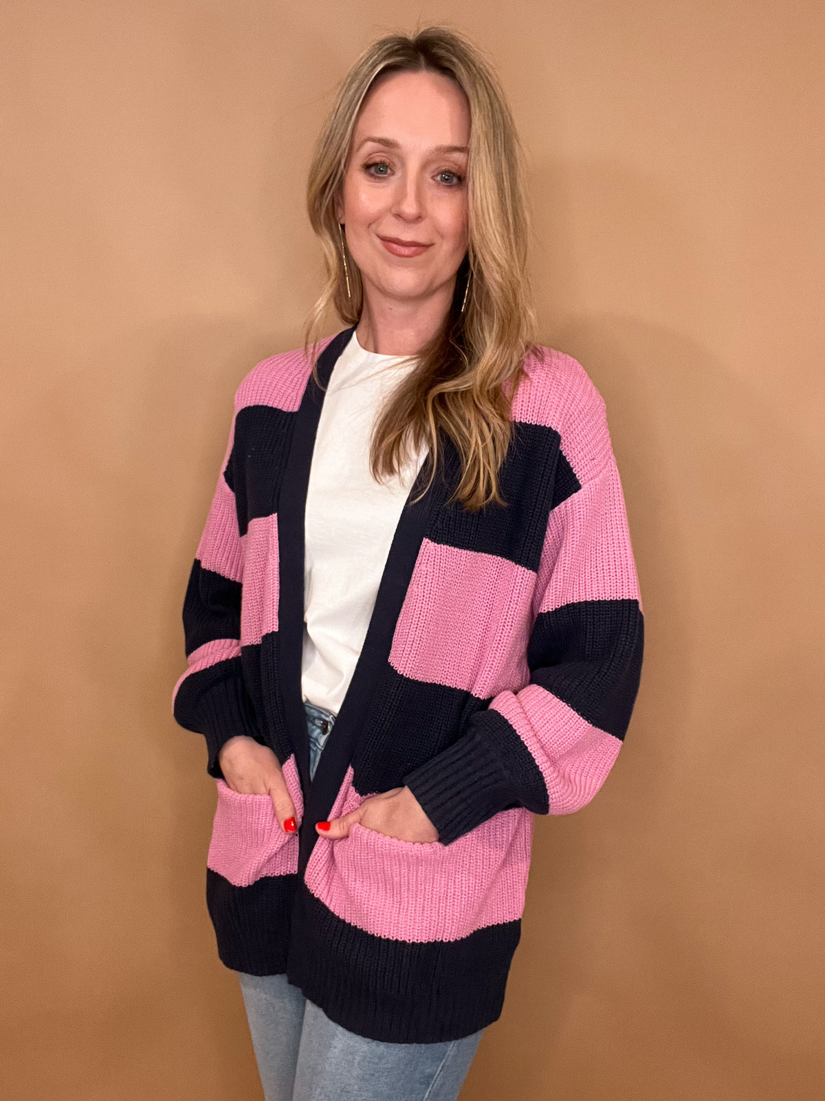 Indulge in the cozy yet stylish Spring Fever Cardigan. With its lilac and navy color scheme, medium chunky knit, and clean front plackets, this cardigan will keep you warm during winter while also being perfect for spring. Plus, the open pockets add a convenient touch. Stay fashionable and comfortable all year round.