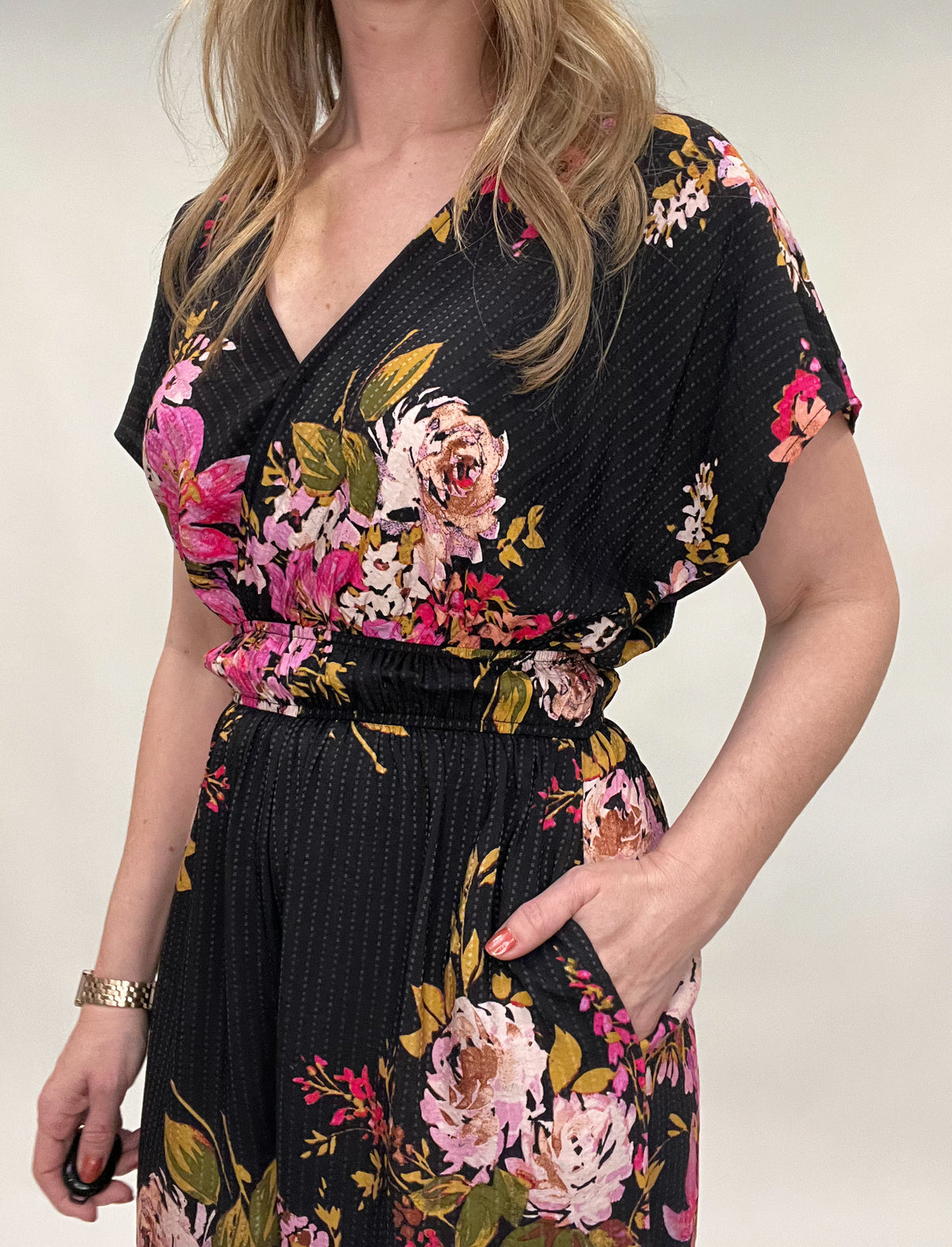 <br>Effortlessly stylish Floral One Piece Jumper is a dream come true. With full length pants and gathered elastic waistline, it offers a comfortable fit. The wrap top, held together by a snap closure, adds a touch of sophistication. Perfect for a light and airy look.