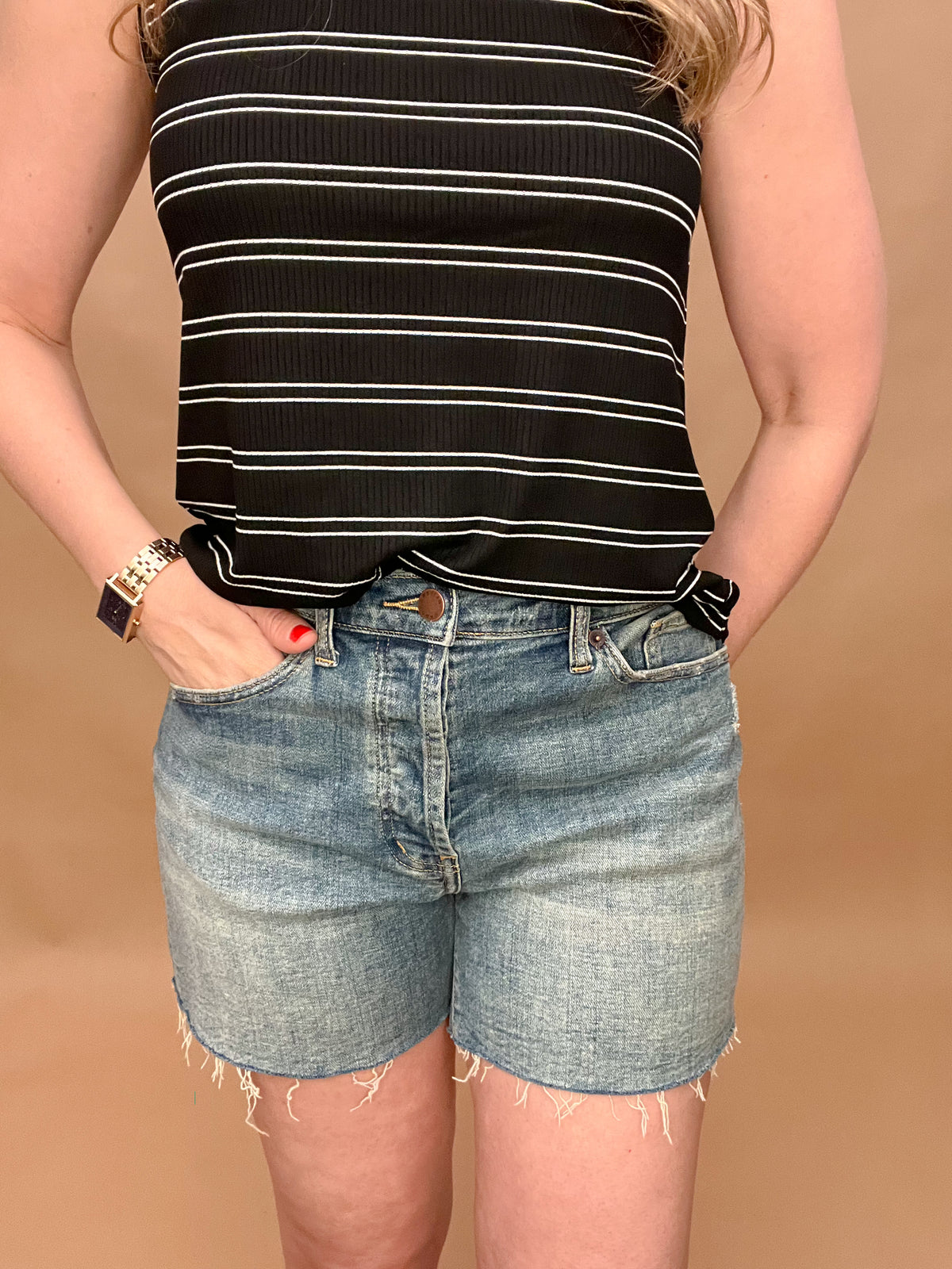 Our best selling Oliver Logan Denim Cut Above shorts are back in stock and ready for warm weather!&nbsp; The relaxed, comfy fit sits high on the waist and cuts off at the thigh. Made from yarn sourced from the Better Cotton Initiative (BCI), these denim shorts feature a buttoned fly and raw hem.&nbsp;