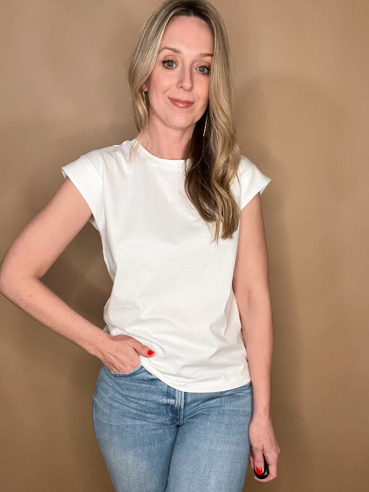 Elevate your wardrobe with our White Shoulder Detail Tee! This closet staple is made from 100% cotton, offering both comfort and style. The shoulder detailing adds a unique touch to this classic white tee. Perfect for layering or pairing with denim cut offs for a timeless warm weather look.