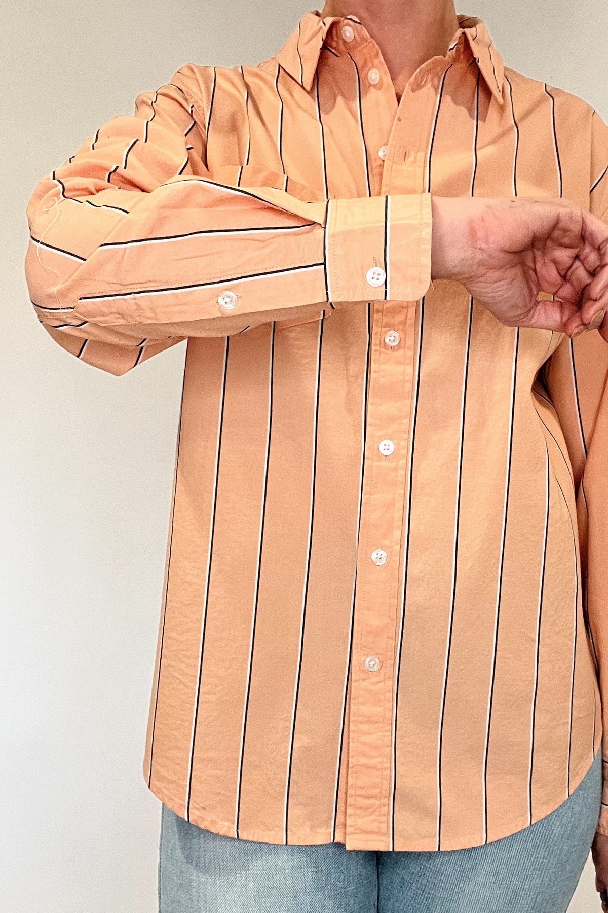 Indulge in effortless elegance with our Just Peachy Striped Shirt. Crafted from 100% cotton, this classic cut shirt features delicate peach tones and black and white pin stripes for a timeless yet modern look. Complete with a single chest pocket, it's the perfect blend of luxury and style.