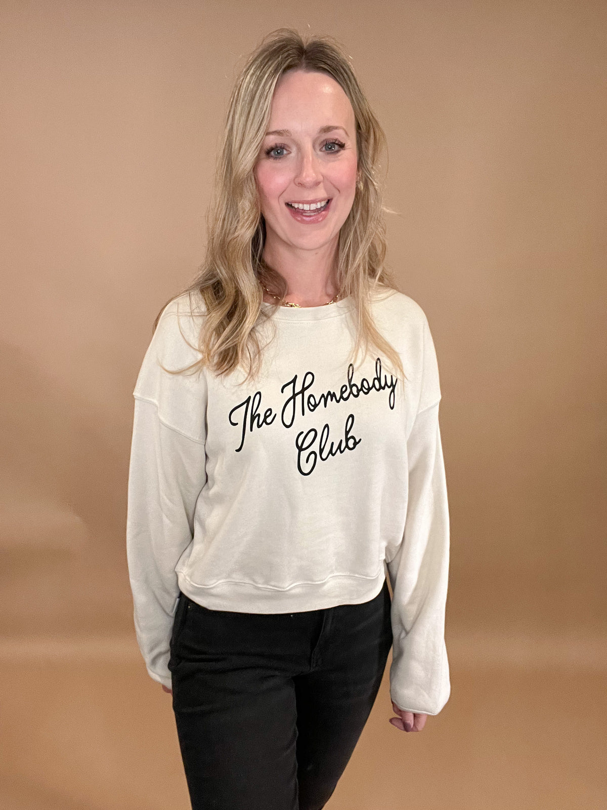 This Homebody Club Sweatshirt is a luxurious statement piece for those cozy days at home. Crafted from cozy cream fabric and black print, this sweatshirt is perfect for you or for a special someone. Wearing it will remind you that it's always homebody season.
