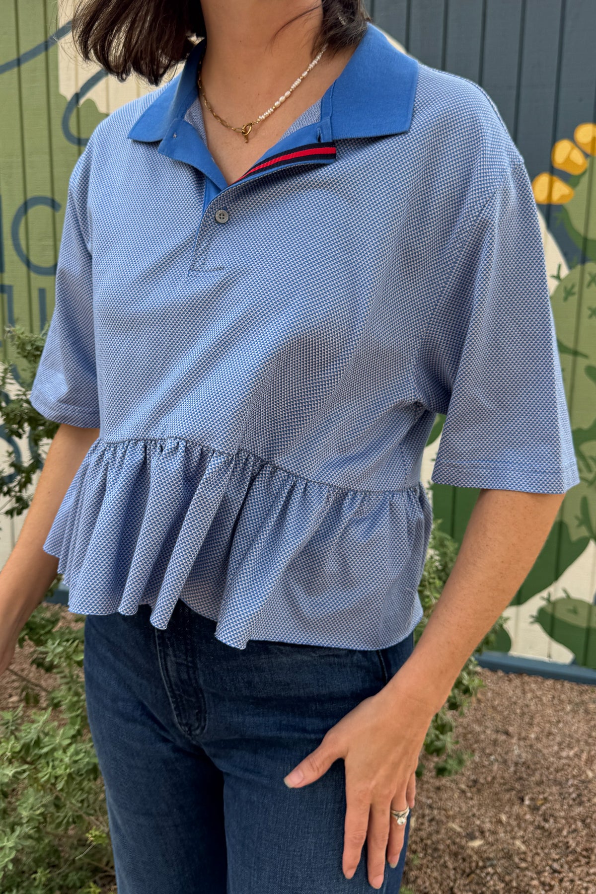 Blue VonVie Bunny Polo made from an upcycled vintage polo with contrasting collar, striped trim, and gathered ruffle hem.
