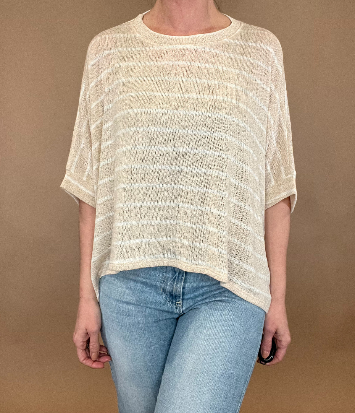 <span><br>Experience comfort and style with our Carefree Lightweight Top. Made for layering over a tank, this loose-fit poncho top is perfect for any casual occasion. Its lightweight design and short sleeves make it an ideal match with light wash denim. Upgrade your wardrobe with this must-have piece. </span>&nbsp;