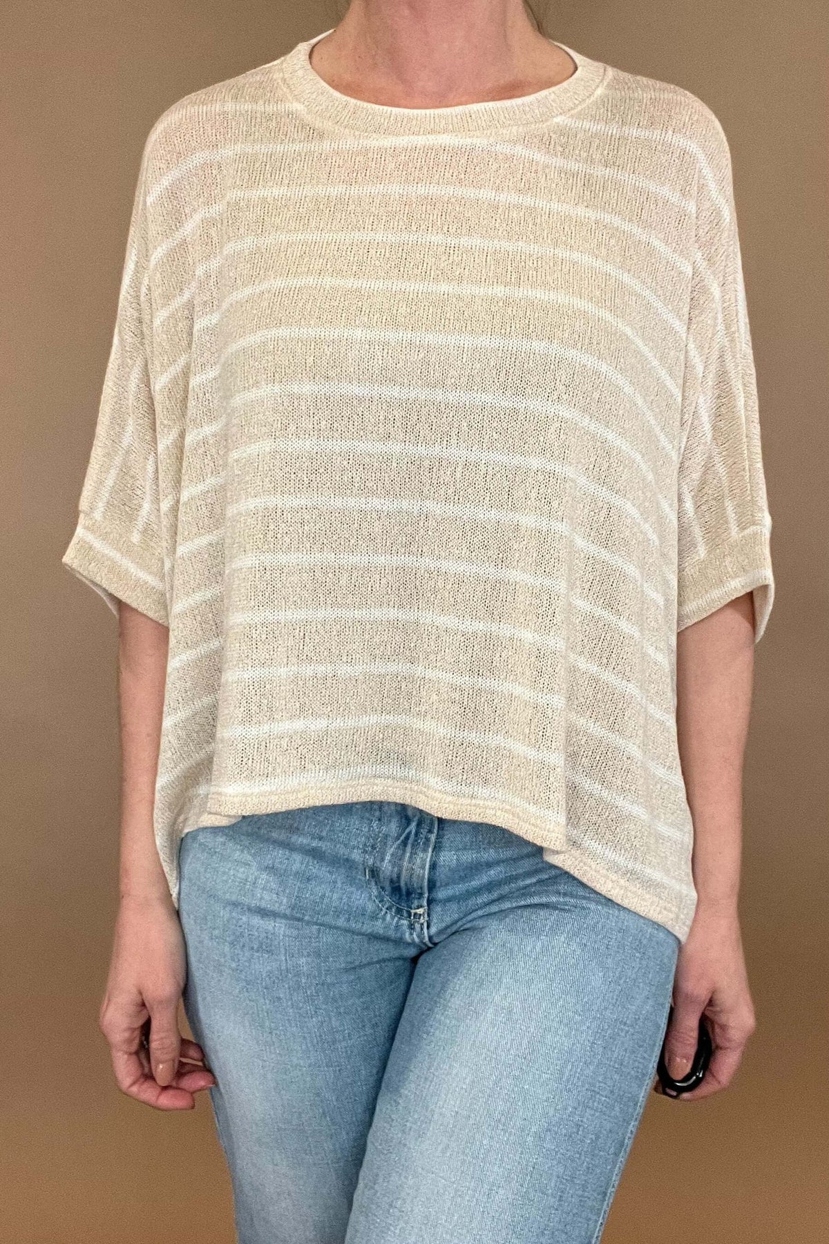 <span><br>Experience comfort and style with our Carefree Lightweight Top. Made for layering over a tank, this loose-fit poncho top is perfect for any casual occasion. Its lightweight design and short sleeves make it an ideal match with light wash denim. Upgrade your wardrobe with this must-have piece. </span>&nbsp;