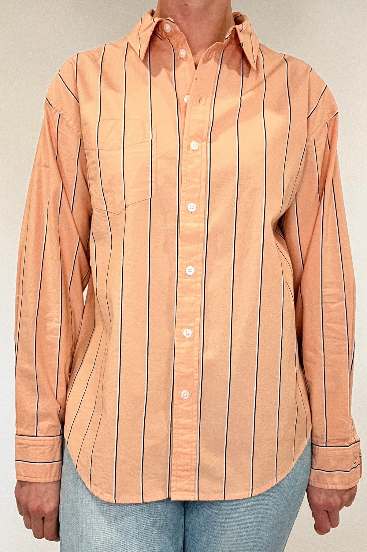 Indulge in effortless elegance with our Just Peachy Striped Shirt. Crafted from 100% cotton, this classic cut shirt features delicate peach tones and black and white pin stripes for a timeless yet modern look. Complete with a single chest pocket, it's the perfect blend of luxury and style.