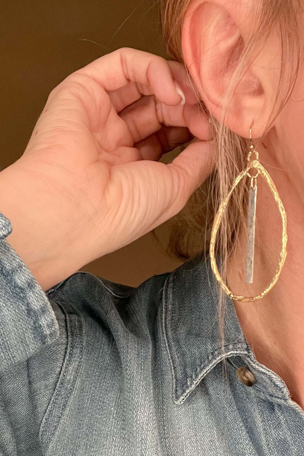 Indulge in the exquisite artistry of these teardrop hoops, handcrafted with hammered Gold Bronze and Sterling Silver accents on Gold filled ear wires. Measuring a regal 2 3/4-inches, these earrings emanate elegance and are proudly made in the USA.