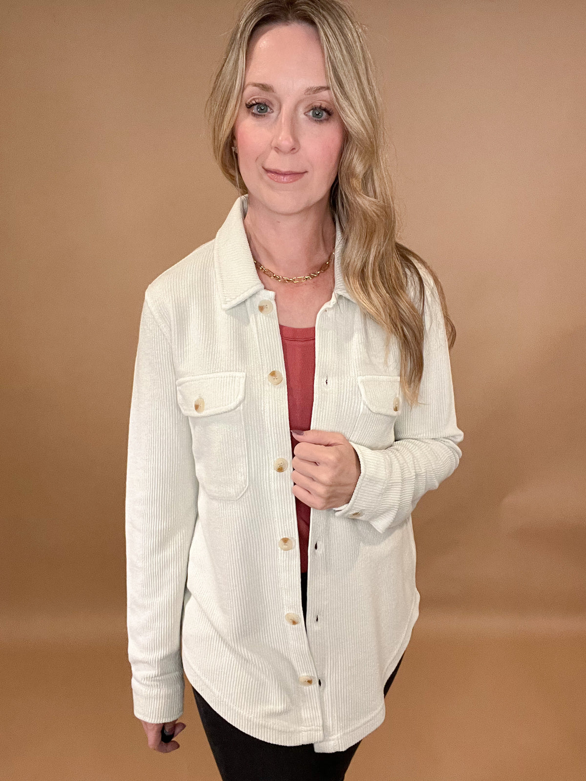 This Knit Cord Shirt is a luxurious, cream-hued piece with an alluring textured knit pattern. Crafted with a comfortable stretch fabric, you can wear it as a shacket or button up for an effortless yet stylish look. Exude sophistication and luxury with ease.