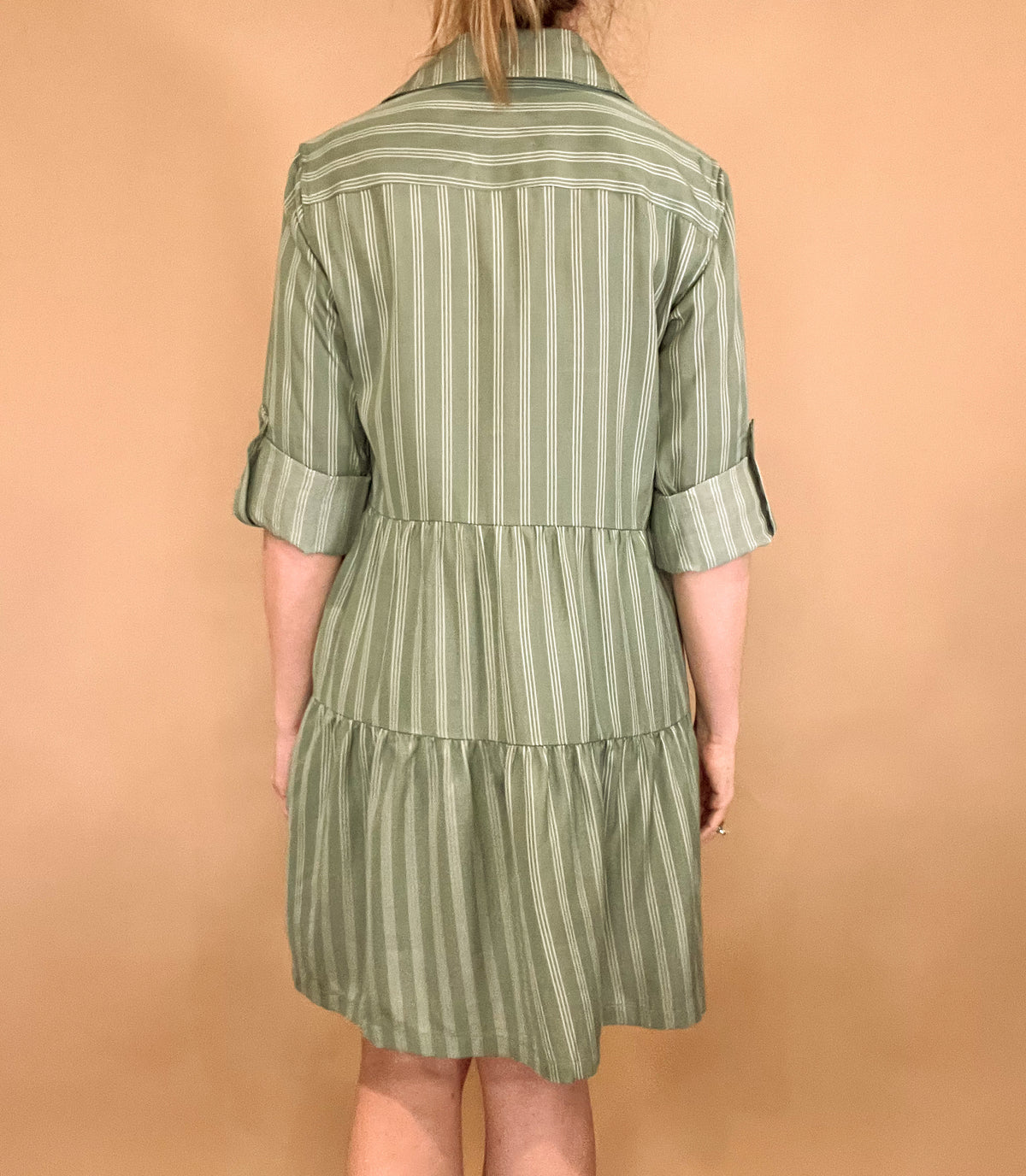 Introducing our Breezy Dress, the epitome of effortless elegance. Made from silky Tencel fabric, this button up tiered dress features a classic white pinstripe design and functional buttoned front pockets. With the ability to roll and secure the sleeves with a button tab, it's the perfect dress for any occasion. Available in blue or green.