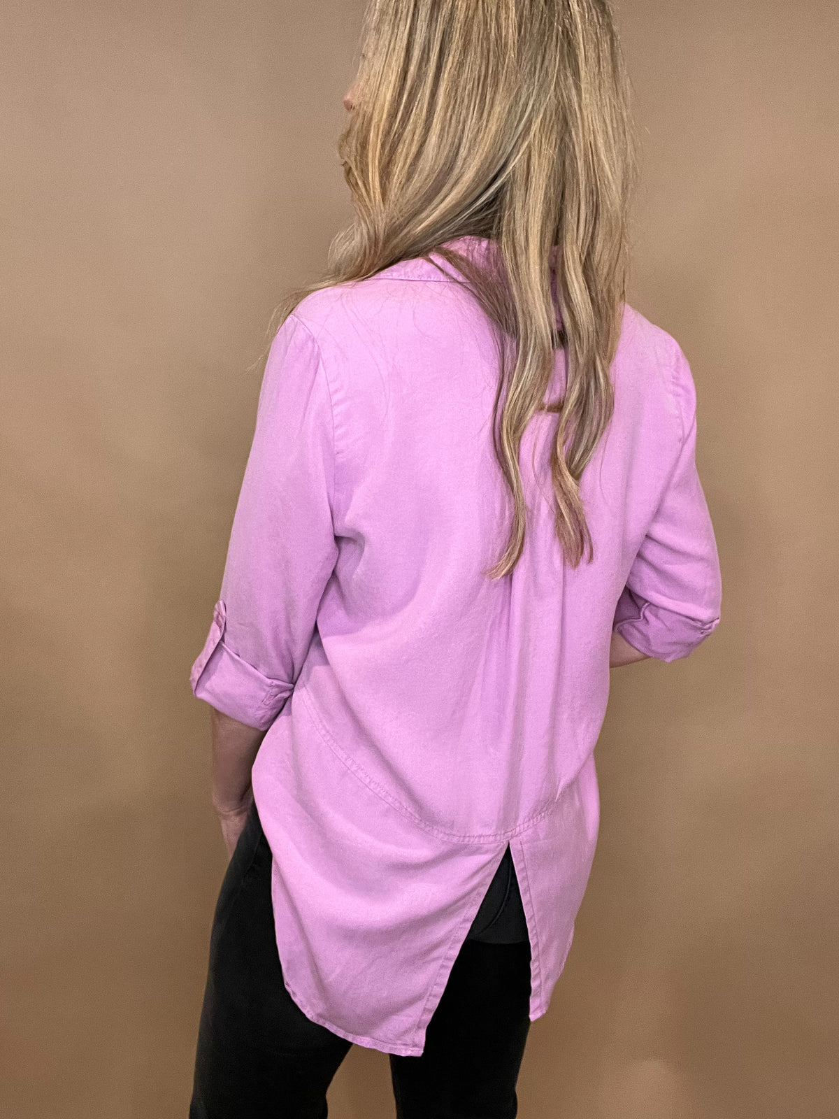 Effortlessly pretty for spring, our Lilac Dream Button Front Top is made from sustainable tencel fabric for a soft and eco-friendly feel. With roll sleeves and slit back tails, this top offers a versatile and chic style. Perfect for the conscious fashionista who loves a touch of femininity.