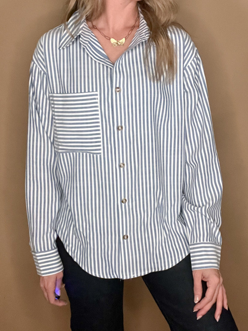 This Classic Stripe Shirt is perfect for the modern sophisticate. Crafted from a luxurious cotton-poly blend, it is soft and stylish while also resistant to wrinkles and maintaining its shape. The classic blue vertical striped design is complemented with a statement front pocket featuring horizontal stripes for an eye-catching finish.