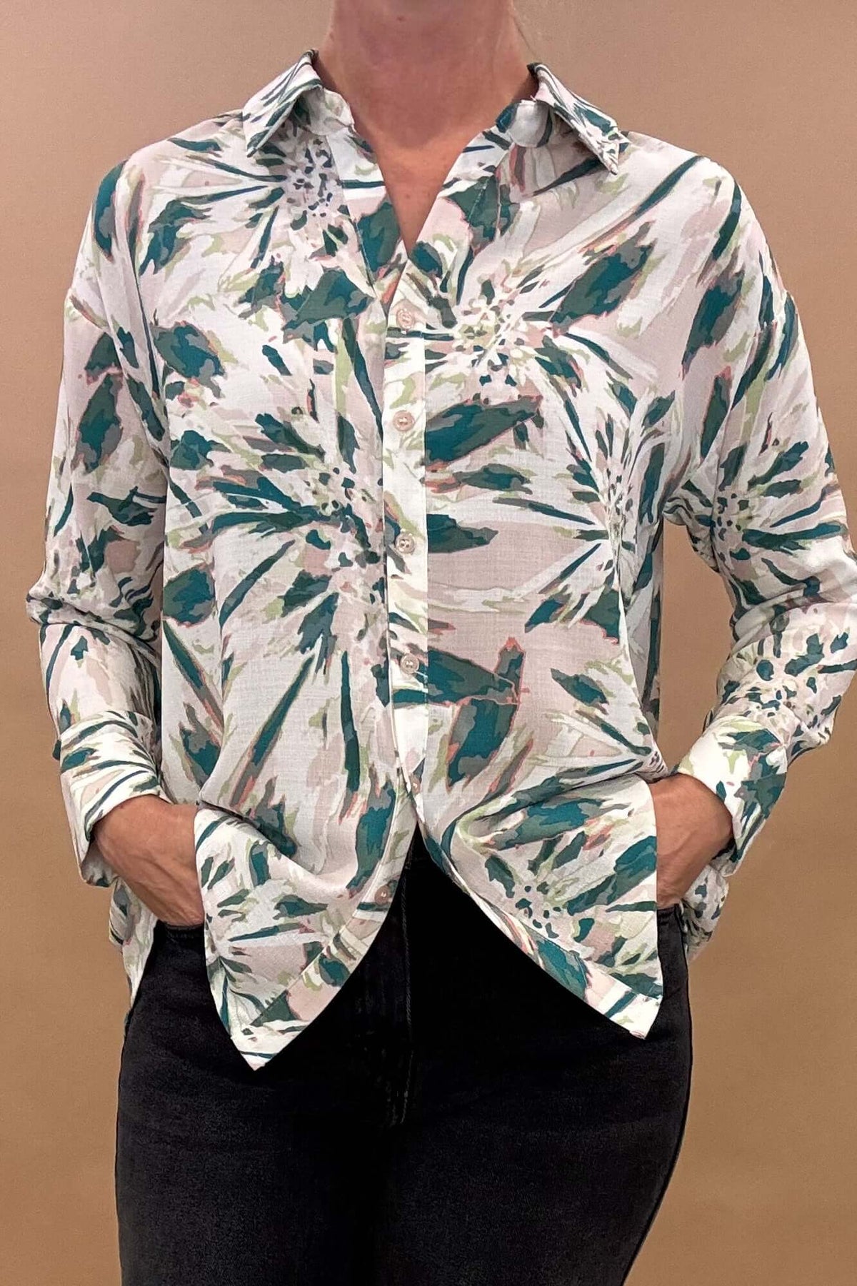 he Front &amp; Back Buttoned Up Blouse features an abstract floral print and a button-up front and back yoke, giving it a sophisticated and stylish look.

Its long sleeves make it perfect for the spring season. Elevate your wardrobe with this unique and elegant blouse.
&nbsp;

Details:

Abstract floral print

Button up front &amp; back on yoke