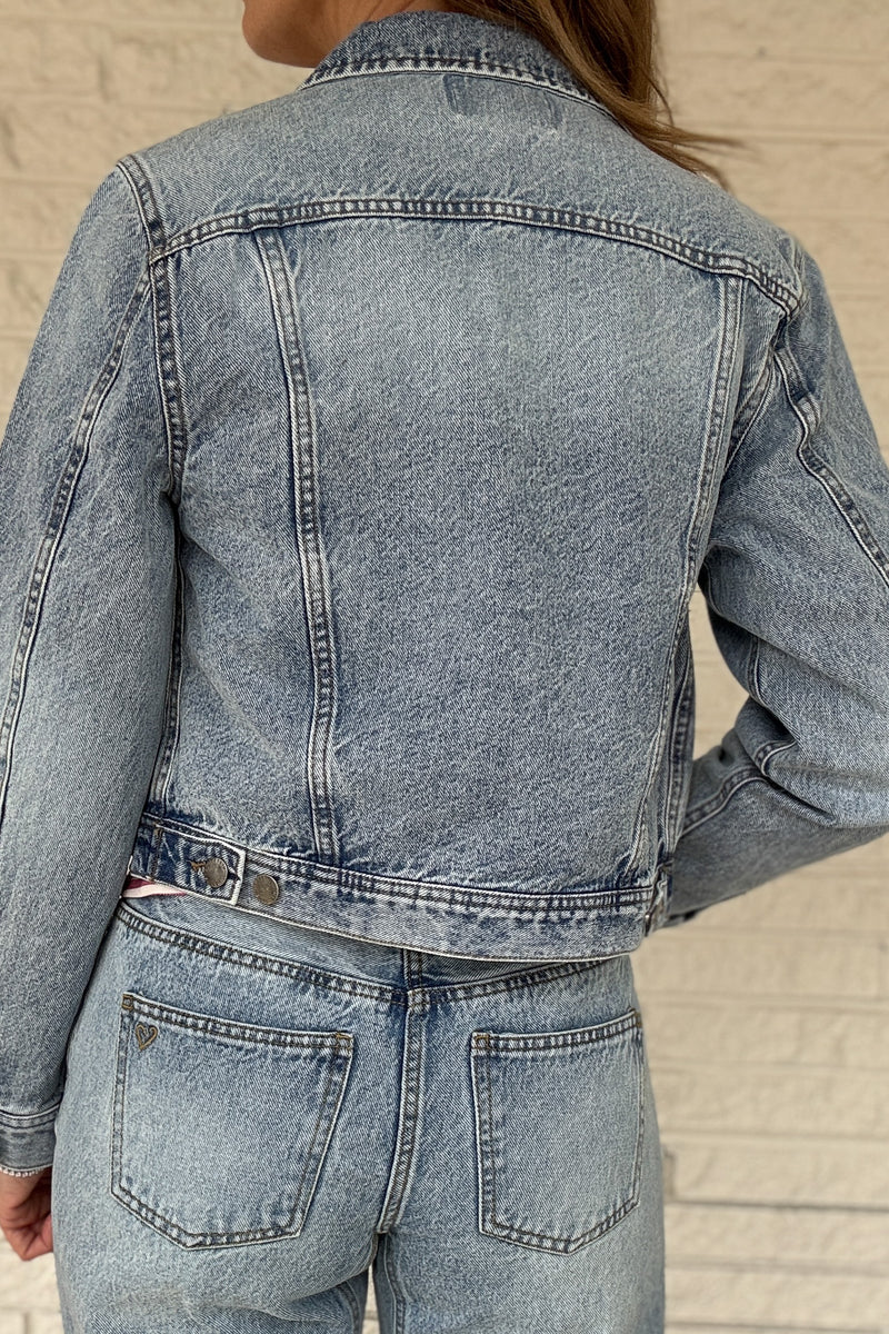 This 100% cotton denim jacket is an easy, everyday layer you’ll reach for all seasons. It has a clean, classic look with a modern cropped length that hits right above the waist on the model. Structured but comfortable, it’s perfect over tees, dresses, and tanks. Women's fashion boutique Blanco Texas Johnson City Texas