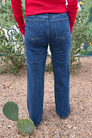 Women’s dark wash high rise wide leg jeans with button detail front pockets at Cotton & Cashmere in Blanco Texas