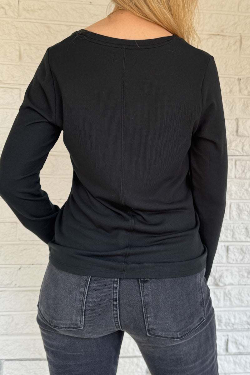 Sleek, soft, and effortlessly classic, this black long sleeve top is a true wardrobe essential. Crafted from silky micro modal with a hint of stretch, it offers a flattering drape and all-day comfort. Perfect for layering or wearing on its own with denim or trousers.