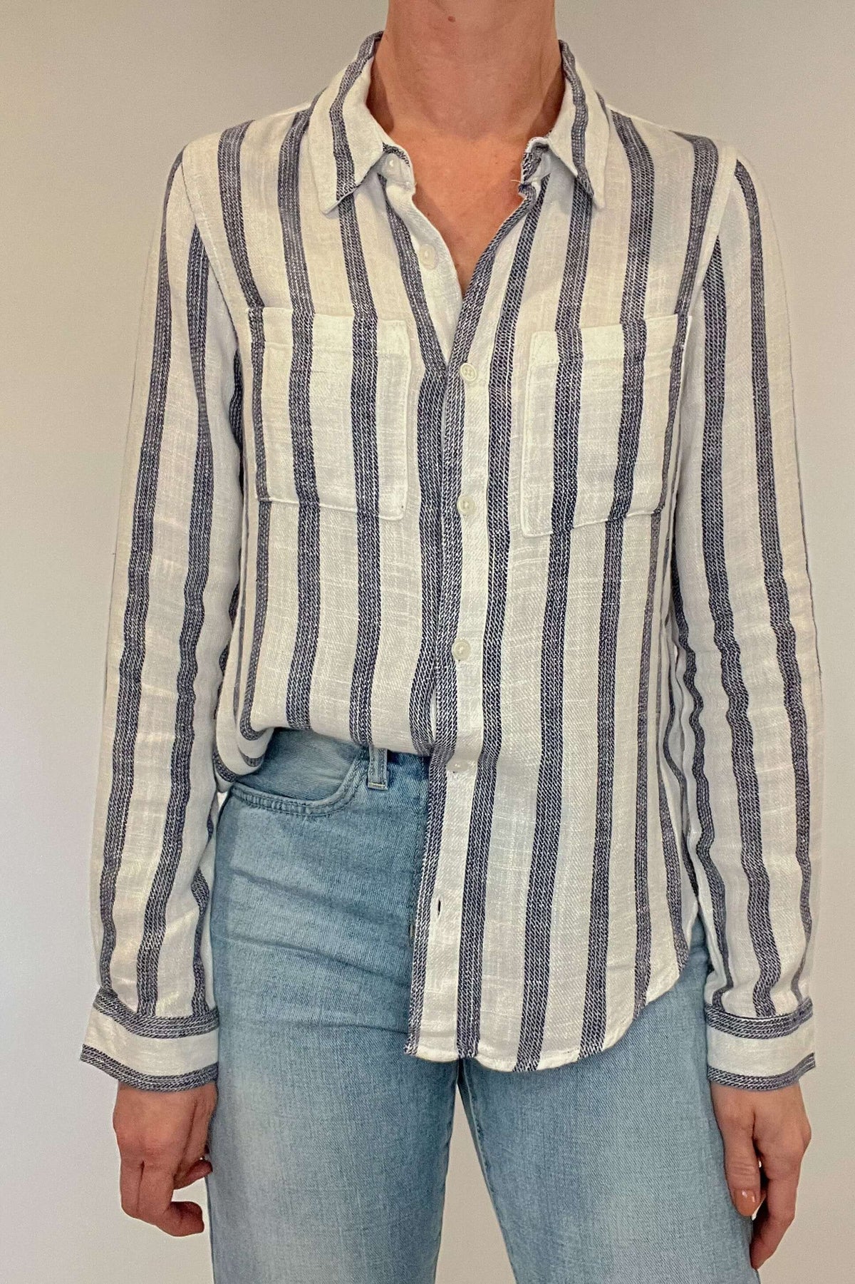 Introducing the Bestie Shirt in Blue, your new companion for the spring and summer season. Made with a luxurious linen blend, this stylish striped shirt is versatile enough to pair with any casual denim and sandals. Let it be your go-to piece for effortless fashion.